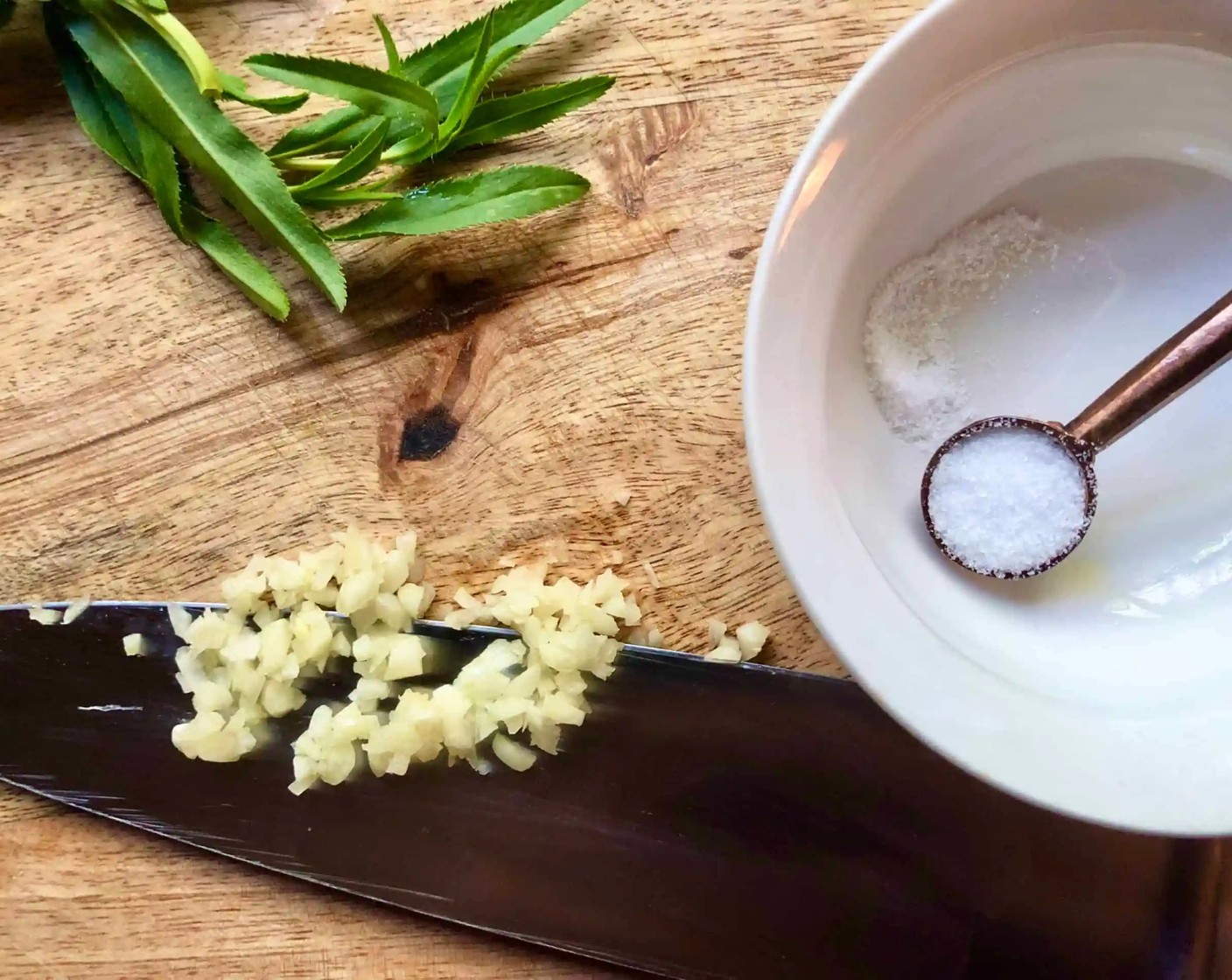 step 1 To make a garlic paste, mince the Garlic (2 cloves) and Fine Sea Salt (1/4 tsp) together, then press down on the garlic with the side of your knife. Move the side of the knife back and forth against the garlic and salt until a paste forms.
