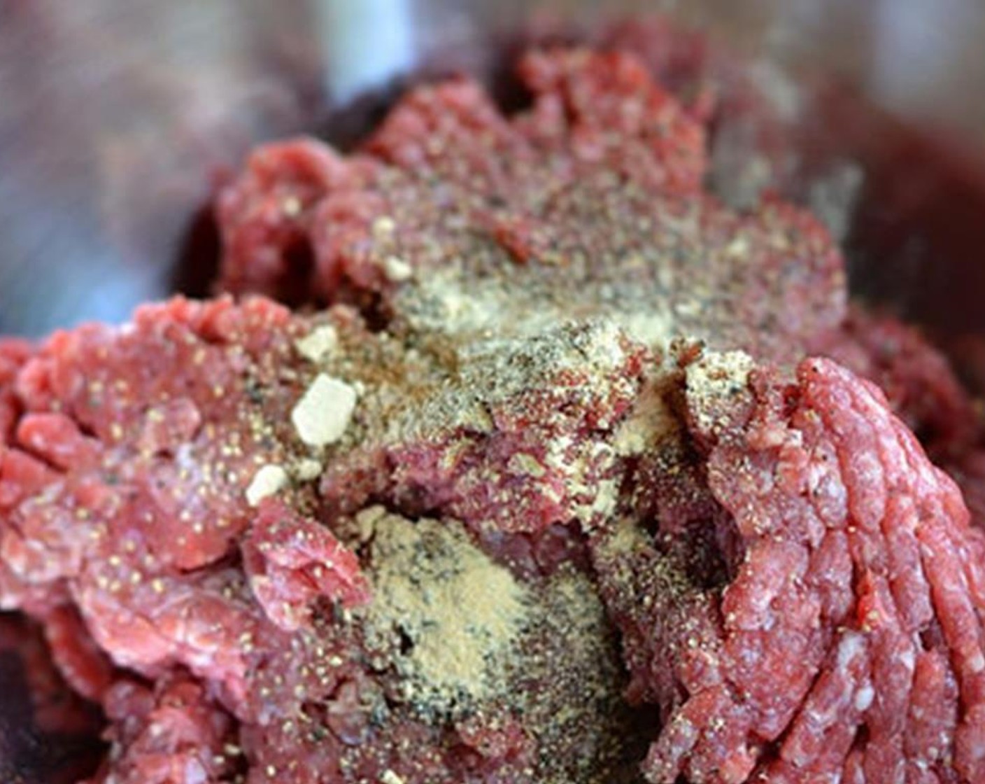 step 2 Carefully use your fingers to mix in Salt (to taste), Freshly Ground Black Pepper (to taste), and Simply Organic Onion Powder (to taste). Don't knead, mangle, squeeze or squidge. Keep the meat fluffy and pebbly.