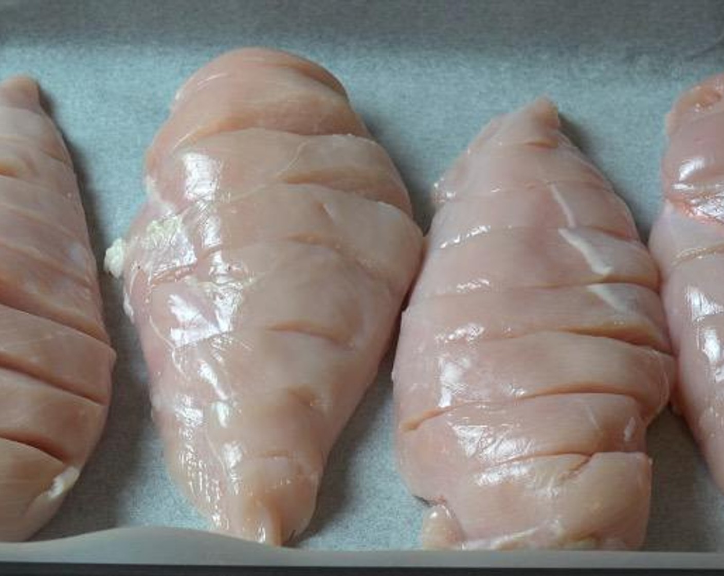 step 1 Using a sharp knife, make shallow cuts horizontally across the Boneless, Skinless Chicken Breasts (4). Transfer to a baking tray lined with non-stick baking paper.