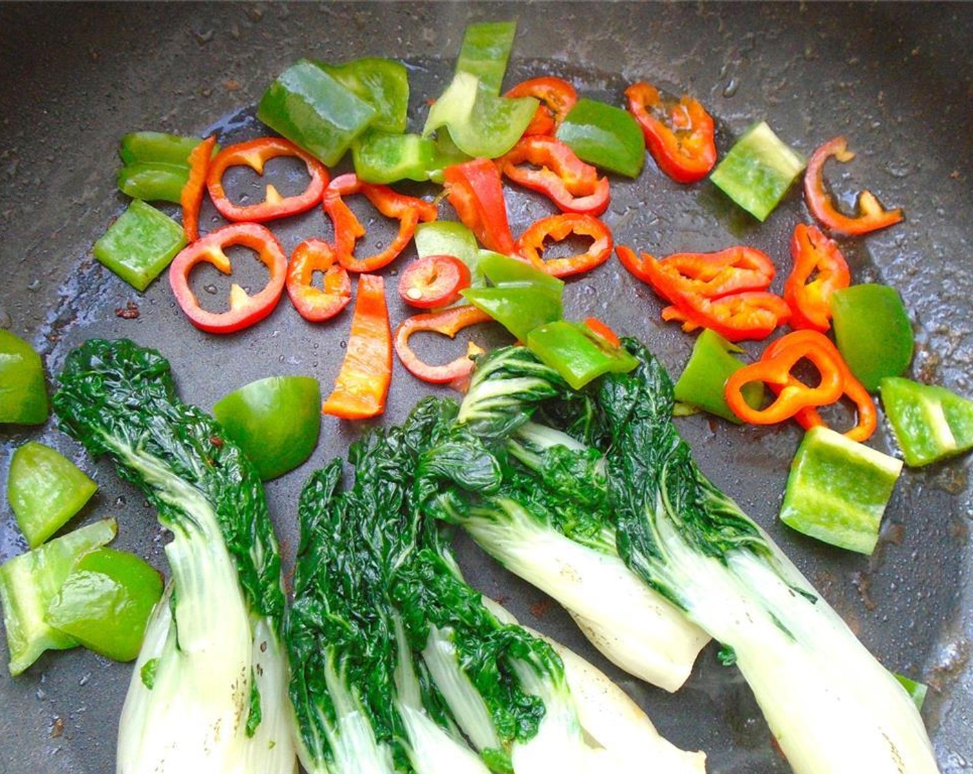 step 10 Add blanched bok choy, Green Bell Pepper (1), and Red Bell Pepper (1) to pan. Stir fry 1 minute.