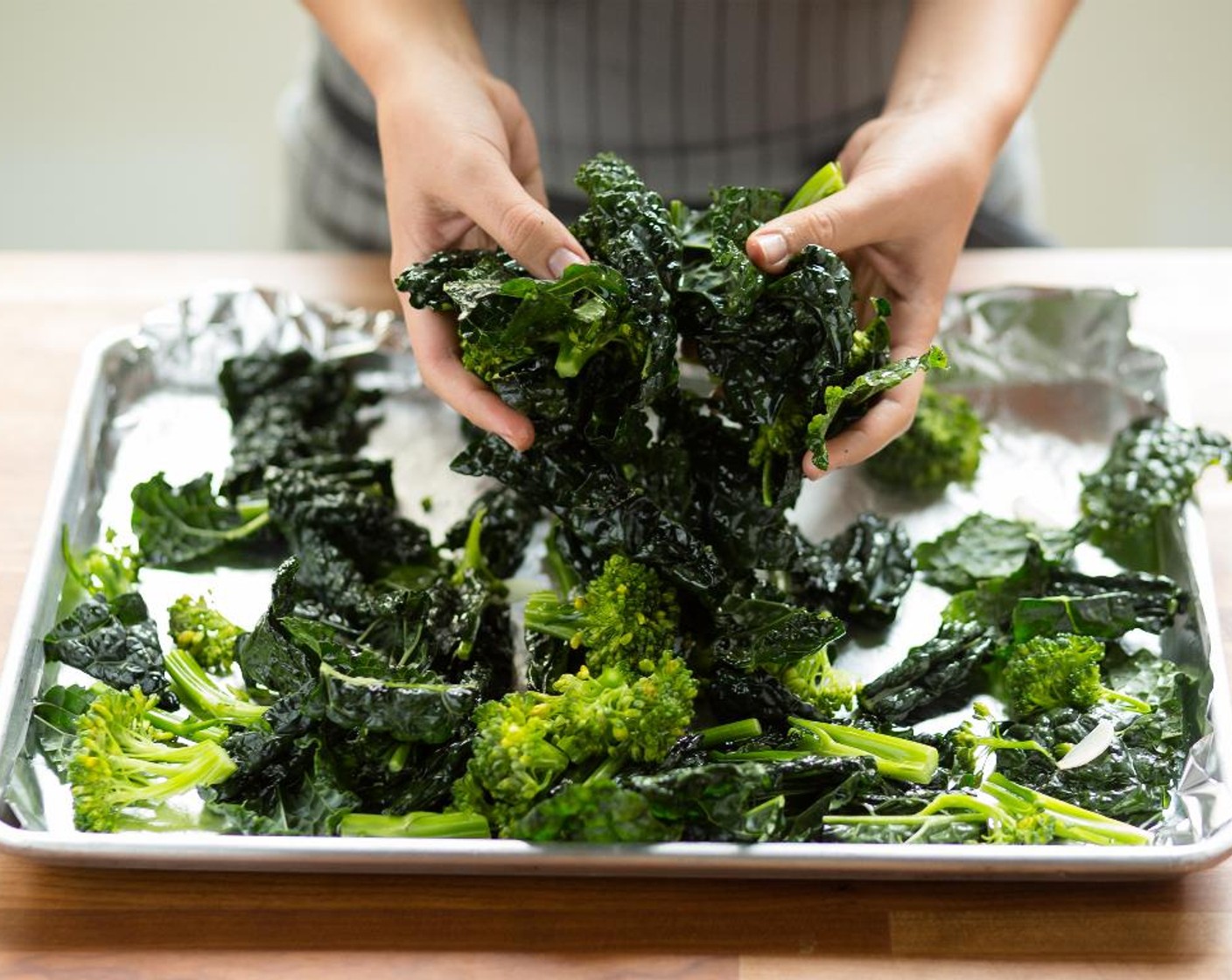 step 7 Place the kale, broccolini and garlic on a sheet pan lined with foil. Drizzle with Olive Oil (1 Tbsp) and season with Salt (1/4 tsp) and Ground Black Pepper (1/4 tsp). Toss to thoroughly combine.