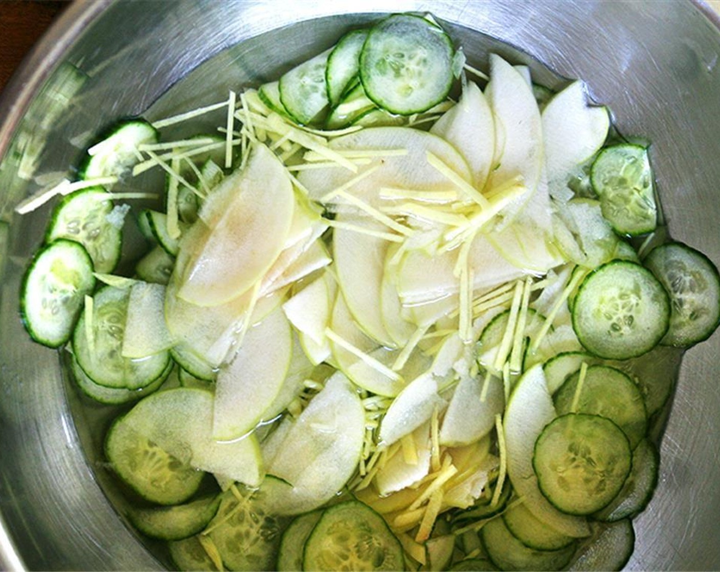 step 3 Toss the apple with cucumbers and Water (2 cups), Rice Vinegar (1/3 cup), Fresh Ginger (1 Tbsp), Granulated Sugar (1/4 cup), and Korean Chili Flakes (1 pinch). Marinate, chilled, turning occasionally, for 1 day, or just eat immediately. No need to marinate these cucumbers and apple slices for very long.