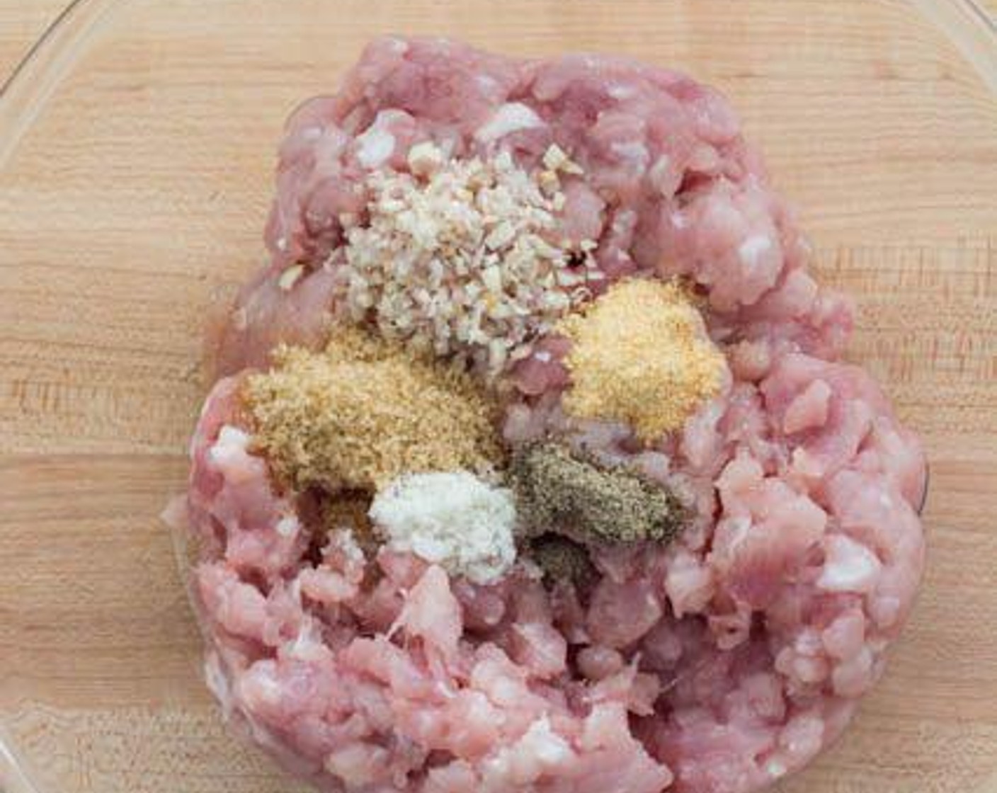 step 4 Add the Lemongrass (3 stalks), Brown Sugar (1 1/2 Tbsp), Simply Organic Garlic Powder (1 tsp), Salt (1/2 tsp) and Ground Black Pepper (1/4 tsp) to the Ground Pork (1 lb).