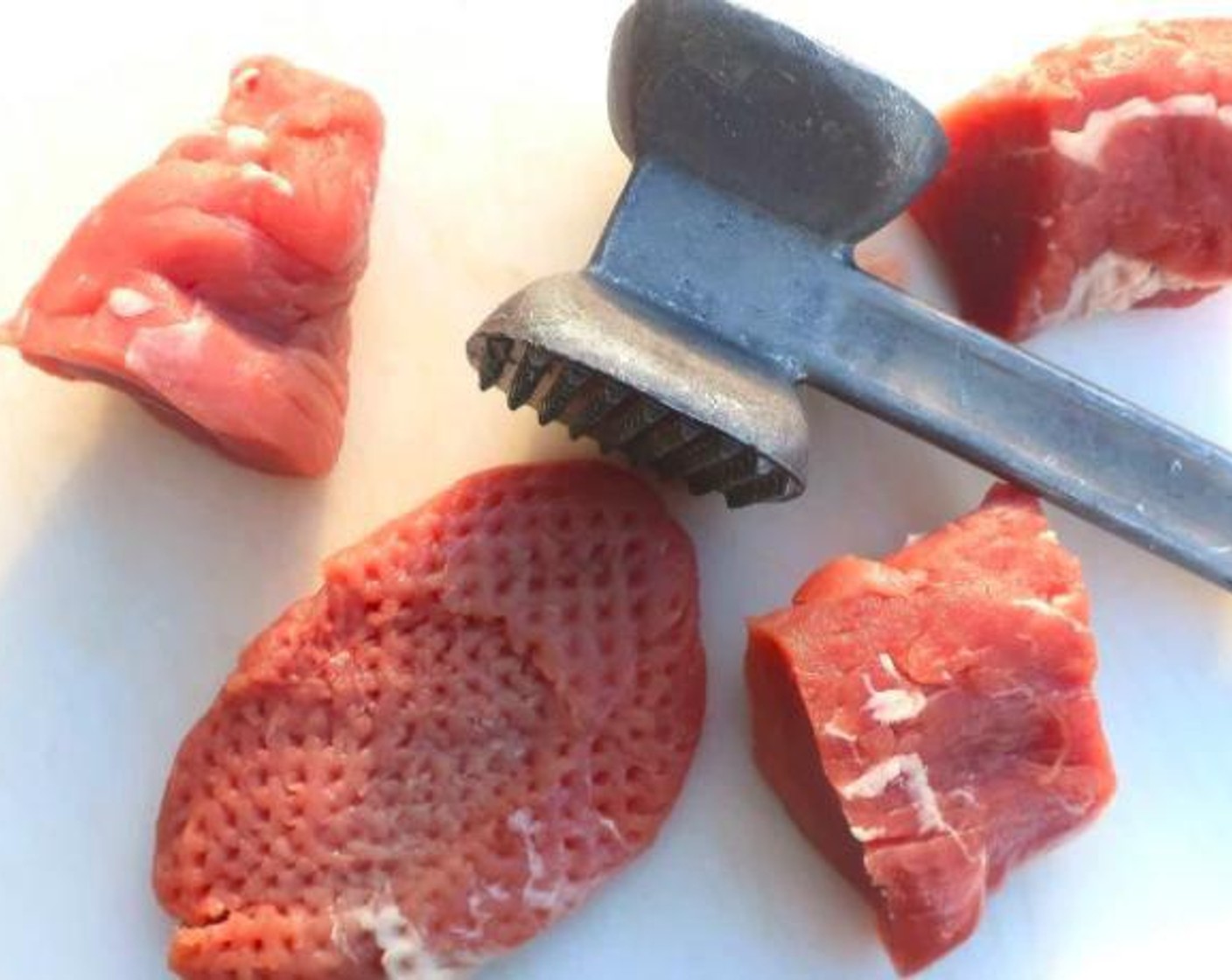 step 1 Cut the Pork Tenderloin (1) into 4 even pieces, then flatten with a meat mallet into medallions.