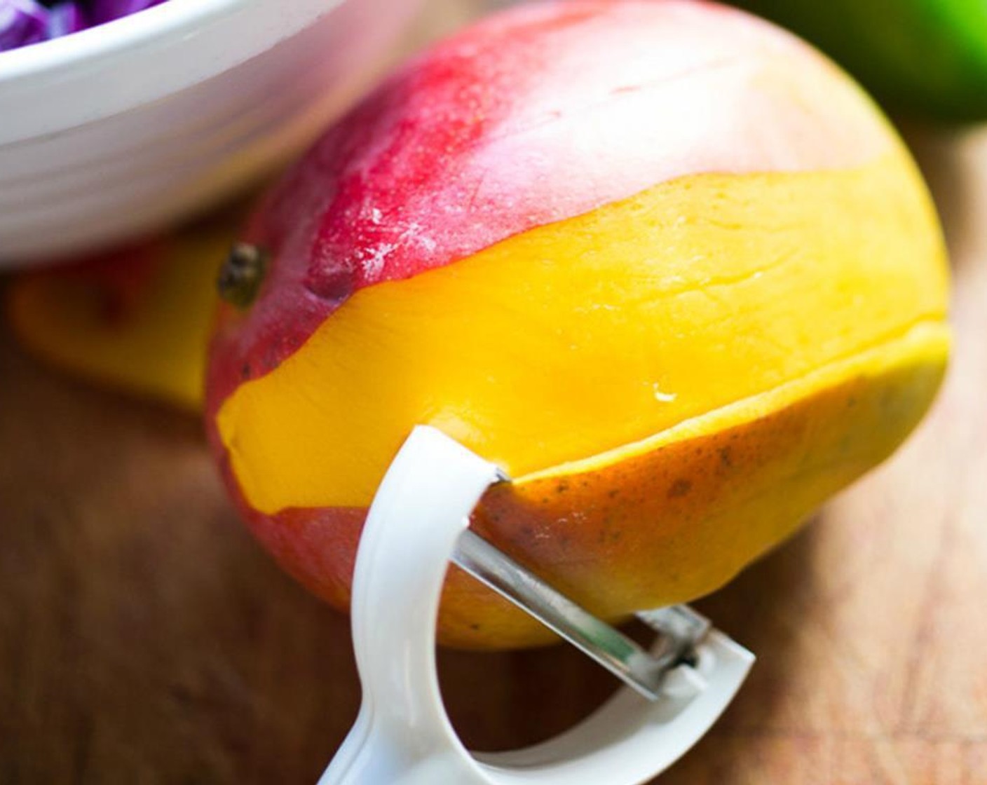 step 1 Peel the Mango (1) a vegetable peeler, then slice into thin strips, cut in half or thirds, place in a large bowl.