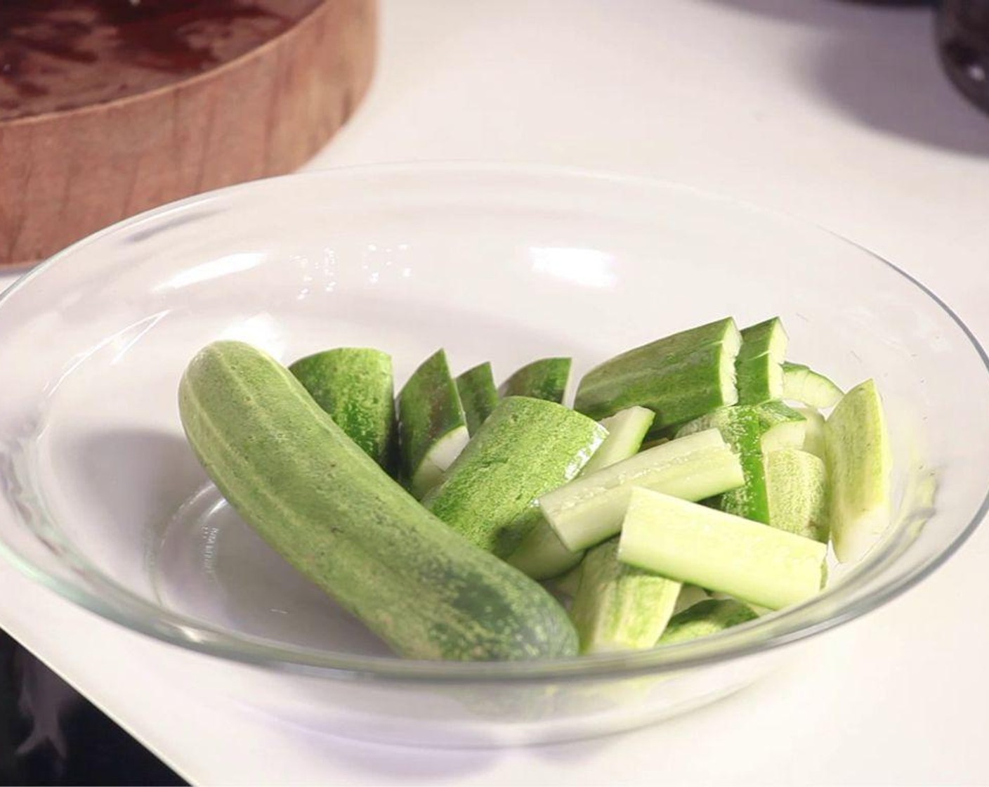 step 1 Cut Cucumbers (3) in half and remove the core inside. Slice into thumb size pieces and then smash cucumber pieces.