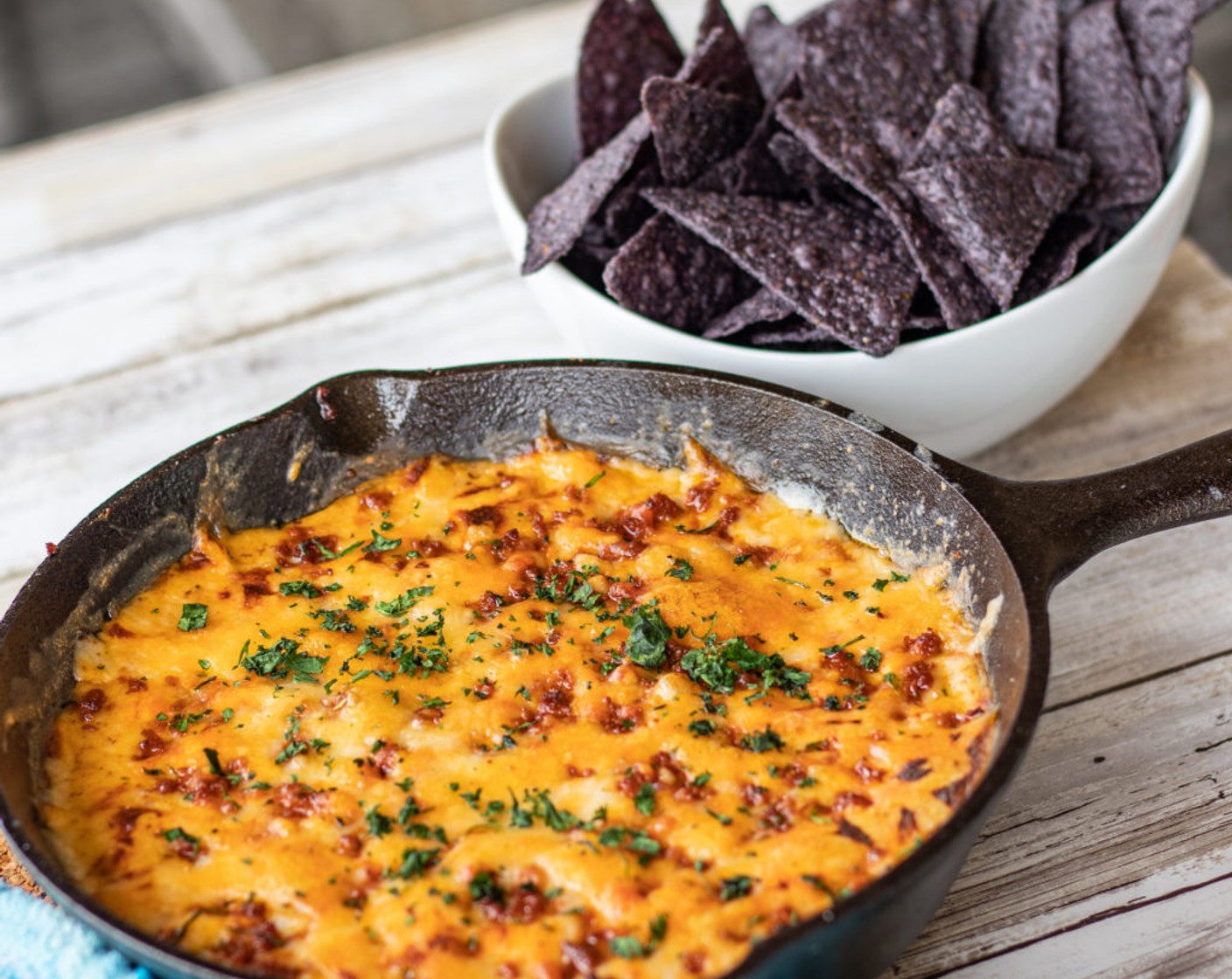 step 9 Remove from the oven, top with some Fresh Cilantro (2 Tbsp). Serve with Tortilla Chips (1 bag).