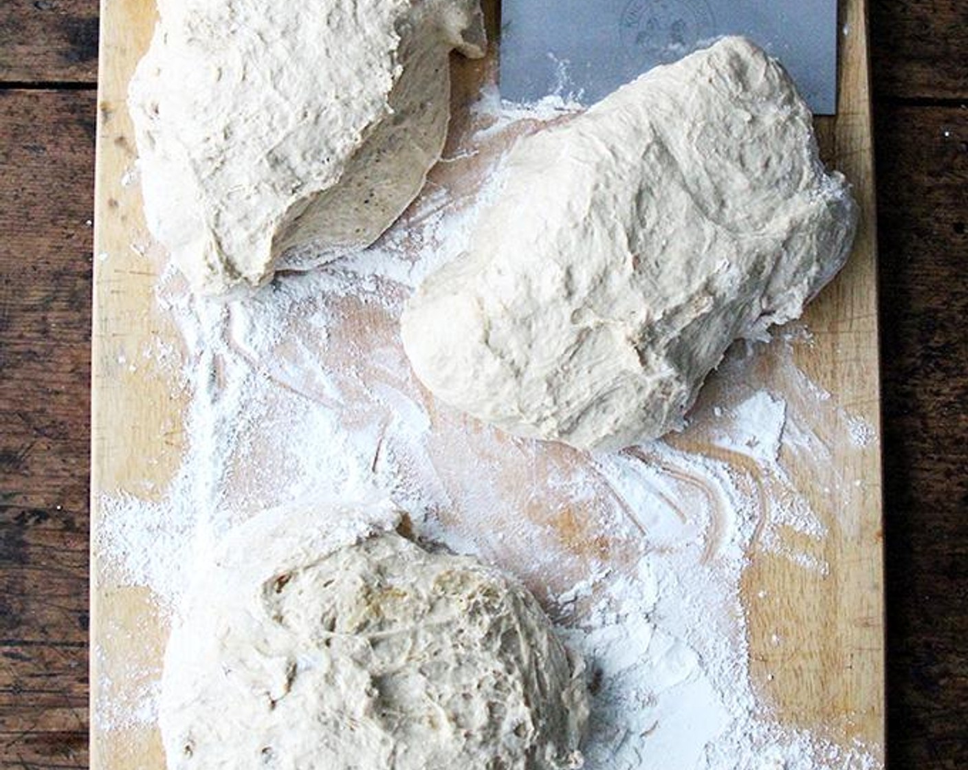 step 6 Set a bowl with water and a pastry brush nearby. Using two forks, deflate the dough by releasing it from the sides of the bowl and pulling it toward the center. Rotate the bowl quarter turns as you deflate, turning the mass into a rough ball.