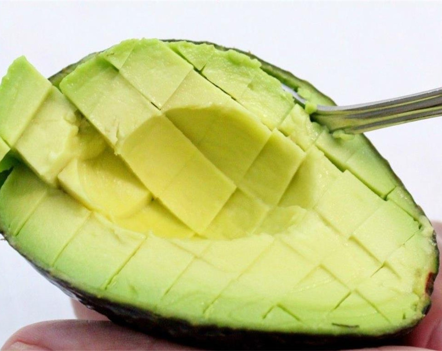 step 4 Pit the Avocado (1) by cutting it in half and removing the seed. Then score and scoop out the avocado.
