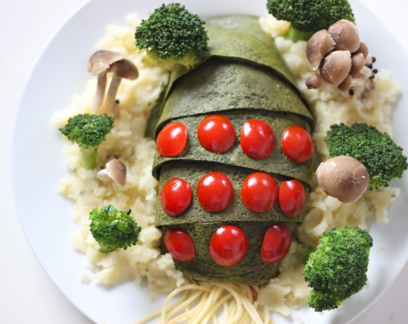 step 11 Place the tomatoes on the face, then put the mashed potatoes around the ohmu. Stick the steamed broccoli and Beech Mushrooms (1 cup) in mashed potatoes. Lastly place boiled pasta into the Ohmu's mouth and you are done!