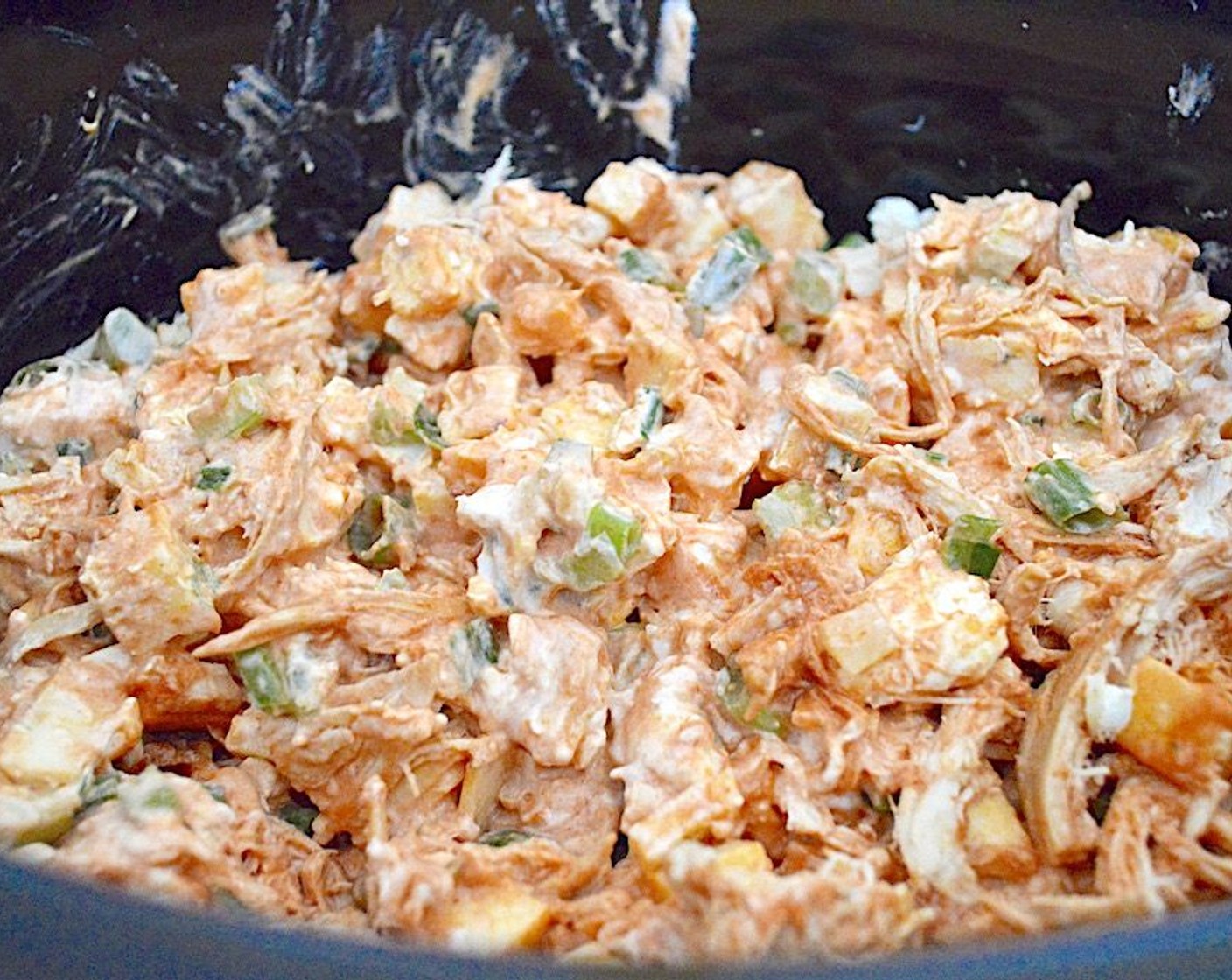 step 1 Combine Rotisserie Chicken (3 cups), Frank's® RedHot® Buffalo Sauce (1 cup), Pepper Jack Cheese (10 slices), Cream Cheese (1 cup), Scallions (4 stalks), Celery (2 stalks), Salt (1 pinch), and McCormick® Garlic Powder (1/2 tsp) in a crock pot and give it a stir.