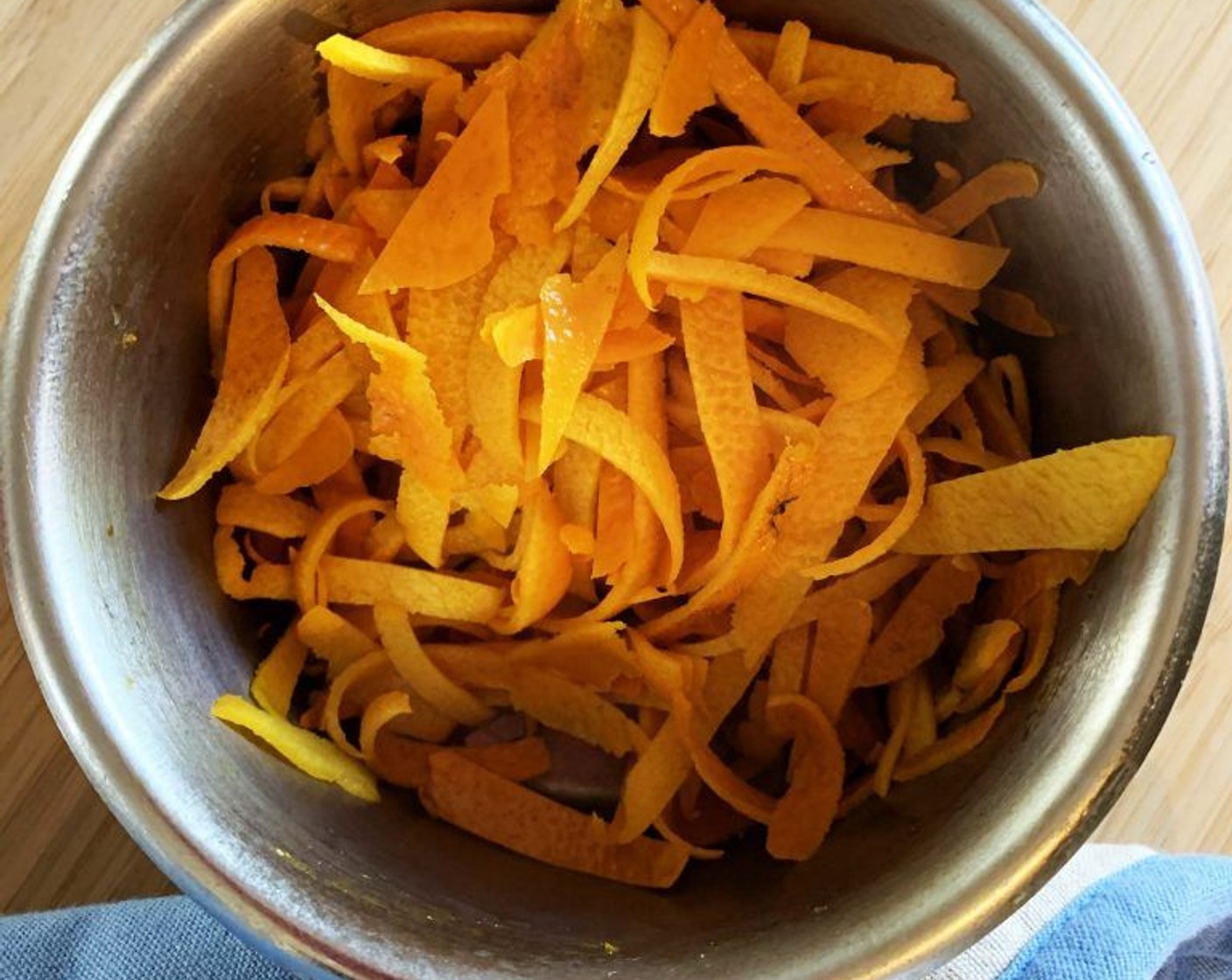 step 3 Meanwhile, cut orange rind into small pieces and bring them to a boil, drain and repeat for 4 times. This will remove any bitter flavor from the skin.