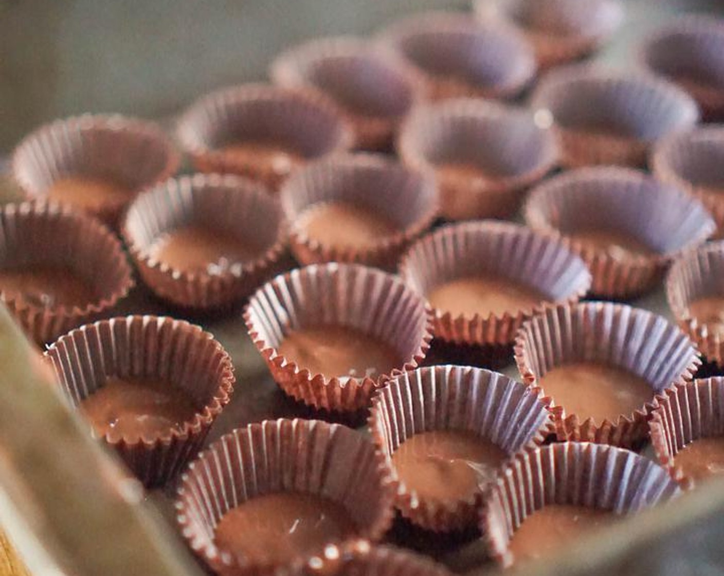 step 5 Pour the chocolate into the muffin liners until they are 1/4 to 1/2 full. They all do not have to be exactly even! Once finished, refrigerate for 20 minutes until hardened.