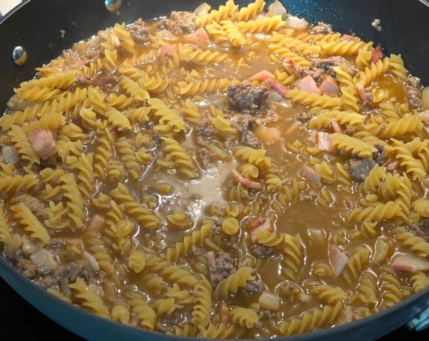 step 4 Add Pasta (1.1 lb) and stir to combine. Cover, reduce temperature to low, and simmer for 20 minutes, or until pasta is cooked through.