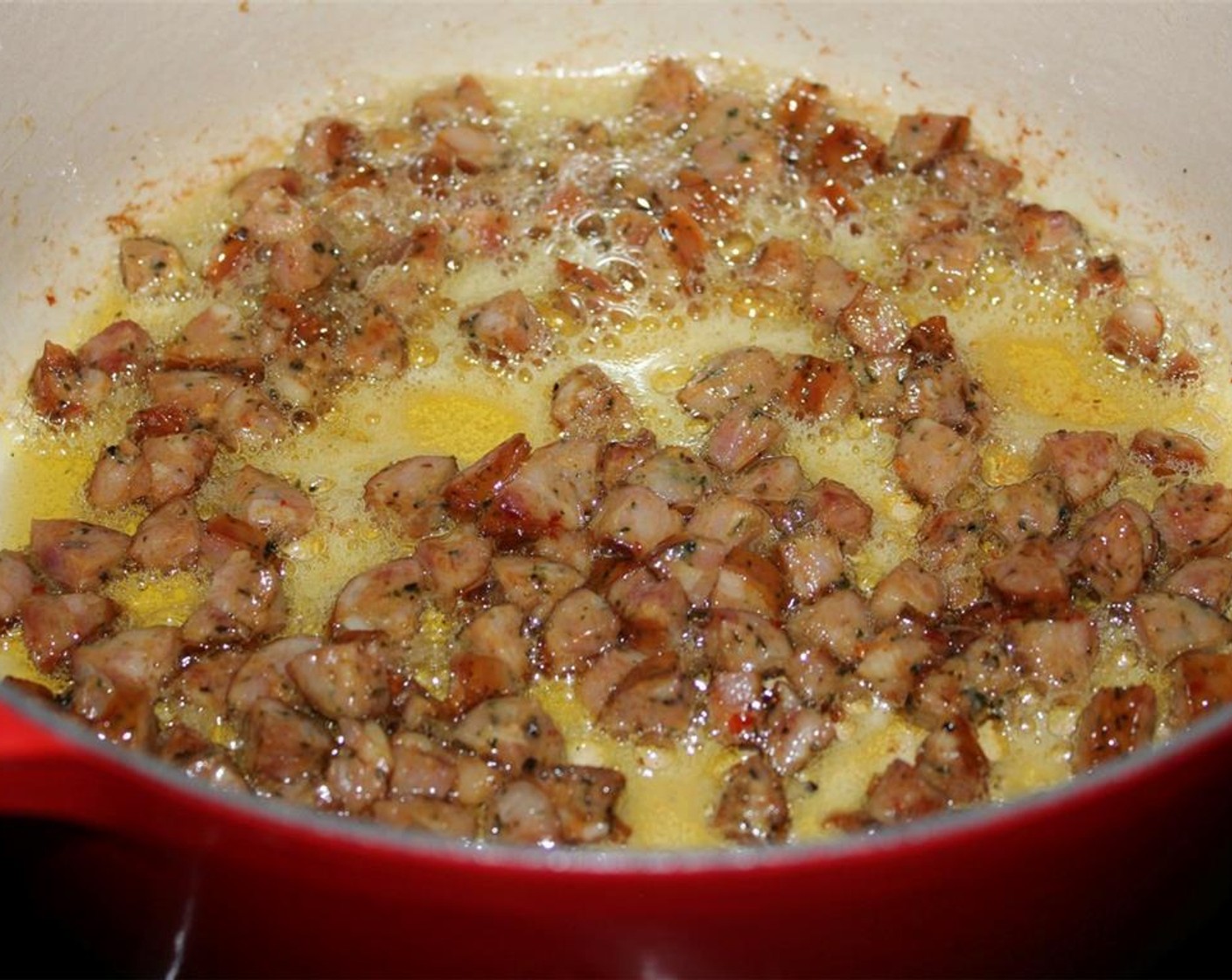 step 1 Heat Olive Oil (2 Tbsp) in a dutch oven or large saucepan. When hot, add the Andouille Chicken Sausages (170 g) and sauté for about 4 minutes until lightly browned.