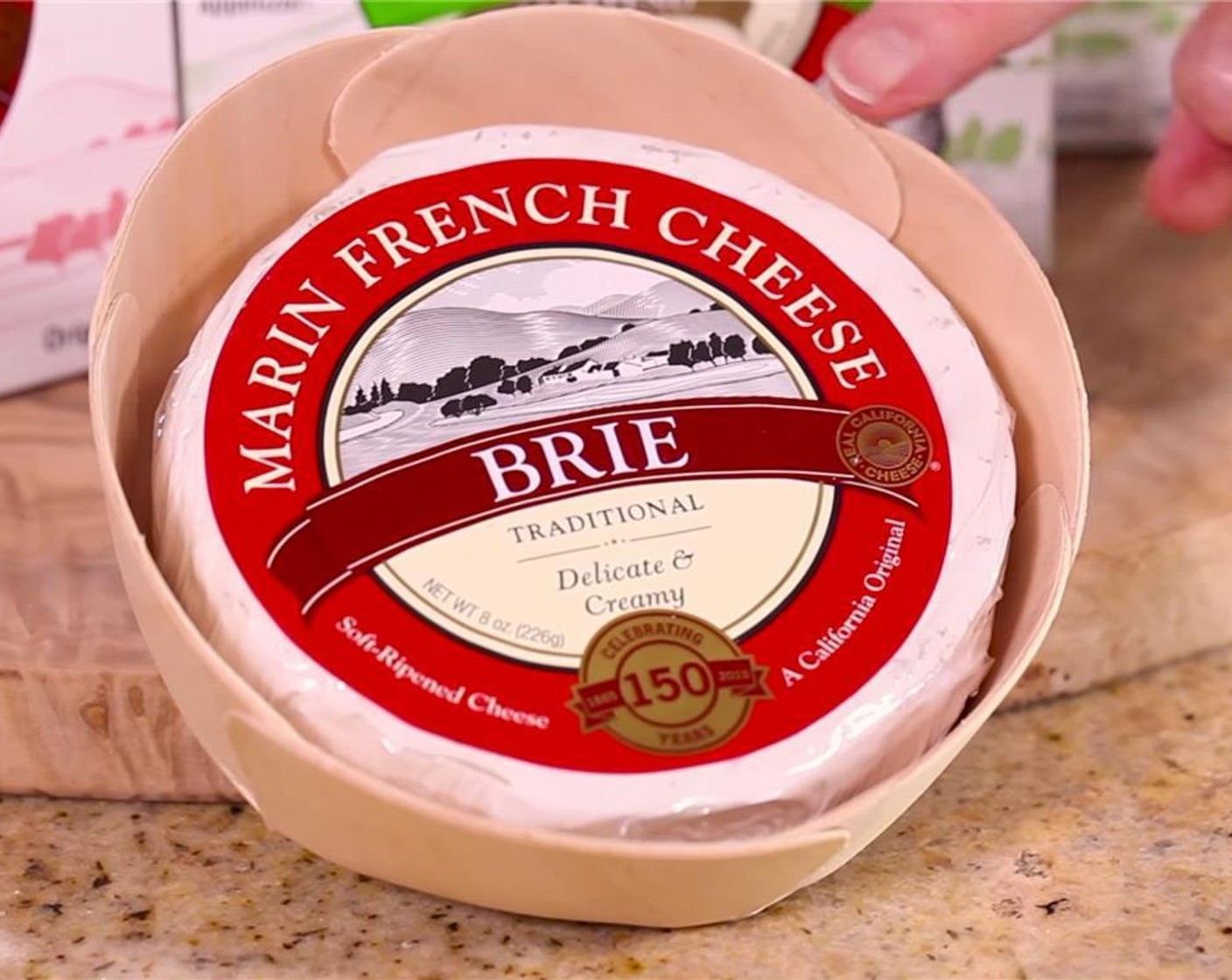 step 1 Preheat oven to 400 degrees F (200 degrees C). Remove Brie Cheese Round (1) from its box and take off the outer wrapping.