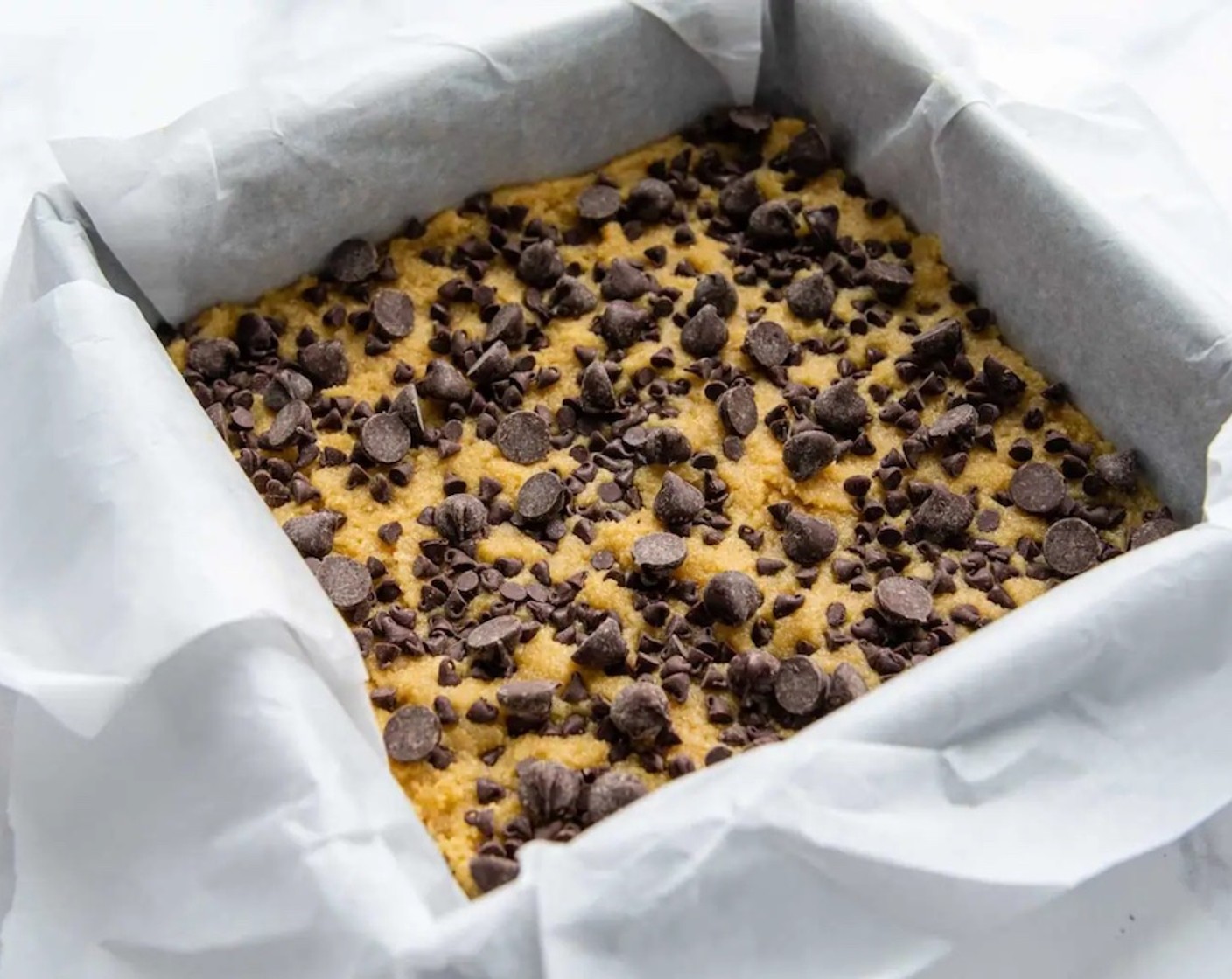 step 4 Spread in the prepared pan and sprinkle on the remaining chocolate chips and/or nuts. Bake for 22-24 minutes, or until edges are golden brown and the center is set.