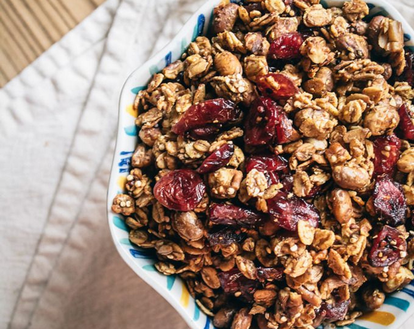 step 8 Once the granola has baked to a toasted golden color, remove and let cool for 2 to 3 minutes. Add baked granola to a large bowl, then stir in Dried Cranberries (1 cup).