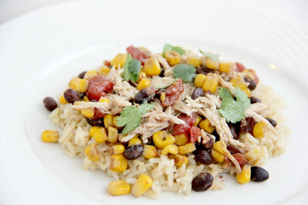 Step 4 of Slow Cooker Southwest Chicken Recipe: Shred the chicken with a fork and serve over Brown Rice (1 1/2 cup) add extra toppings including more fresh cilantro or green onions. Serve and enjoy!