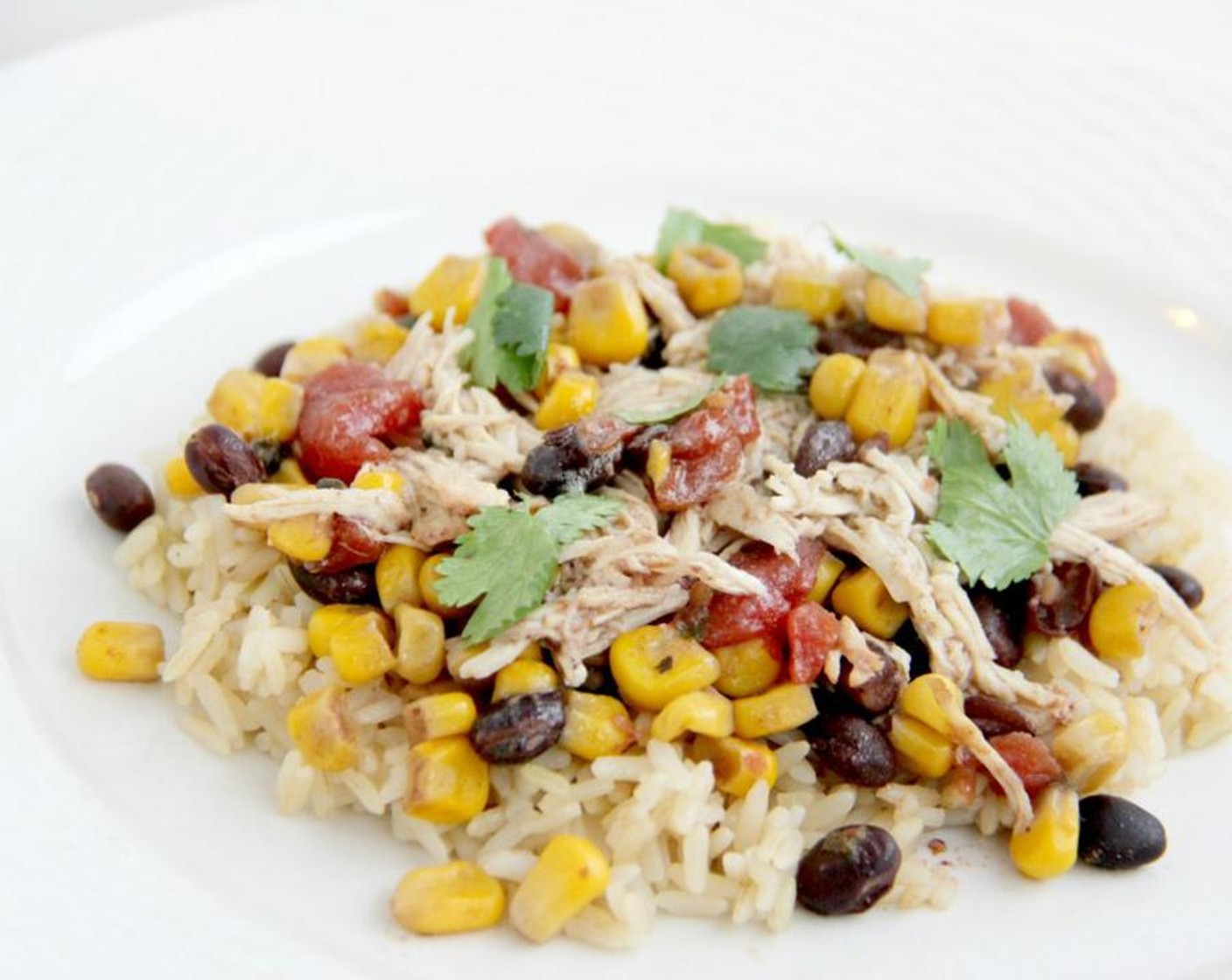 step 4 Shred the chicken with a fork and serve over the cooked Brown Rice (1/2 cup) add extra toppings including more fresh cilantro or green onions. Serve and enjoy!