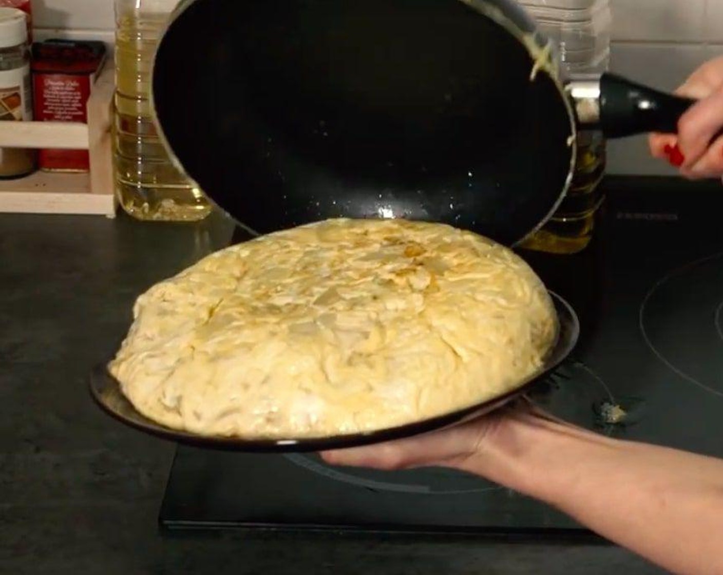 step 5 Lay a flat pan lid or a plate on top and invert the tortilla. Add more oil to the pan if needed, and slide the tortilla back into the pan, cover and finish cooking until set and lightly brown, about 3 minutes more.