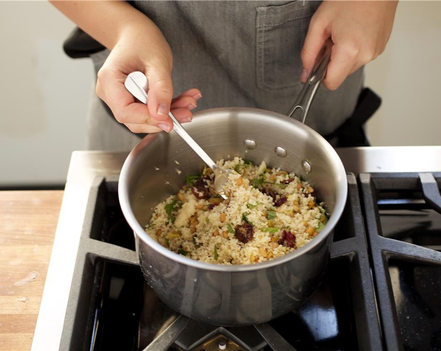 step 9 Fluff couscous with a fork. Add the roasted Pine Nuts (2 Tbsp), mint, lemon juice and zest, Dried Fruit Mix (2 Tbsp) and Salt (to taste). Gently stir to combine, and keep warm for plating.