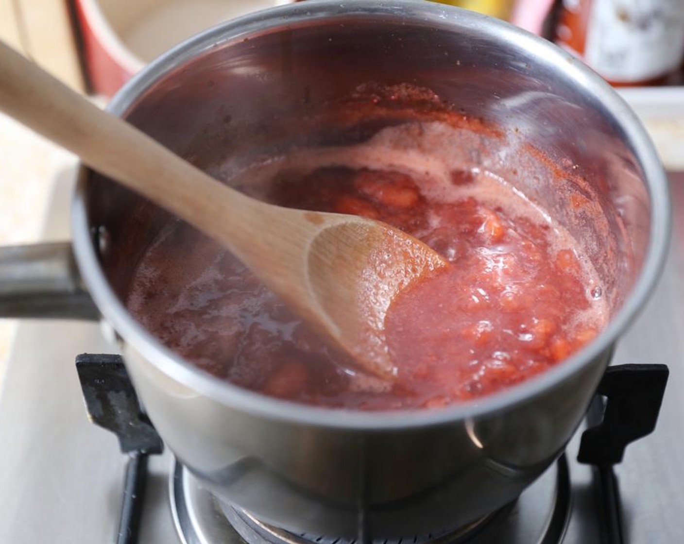 step 3 Cook the fruit over a medium heat, allowing it to come to a boil but stirring constantly until the fruit thickens. This should take around 20 minutes.