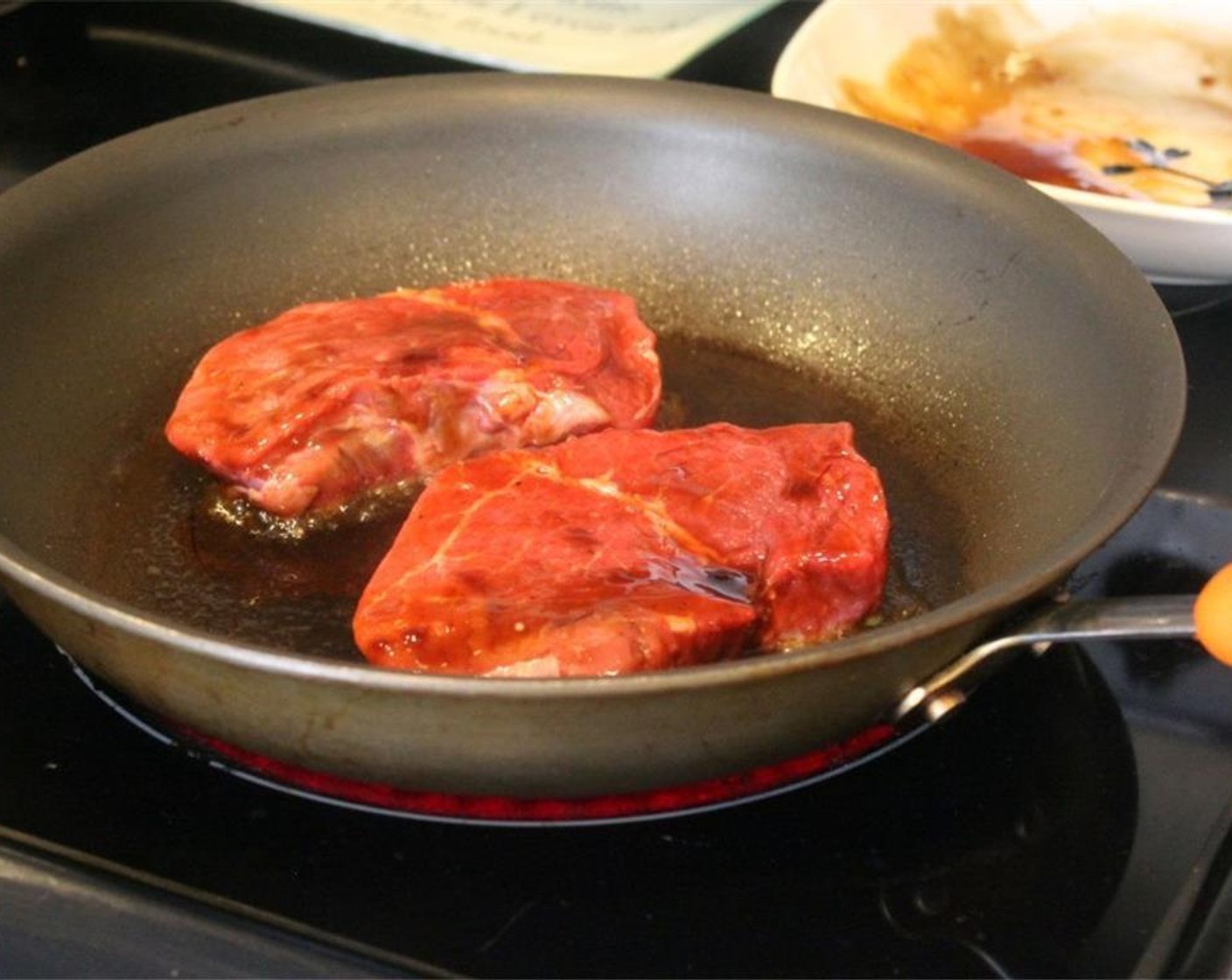 step 5 Heat a large skillet to medium-high heat with a drizzle of oil and add the steaks. The steaks should sizzle when you place them in the pan. If not, turn the heat up.