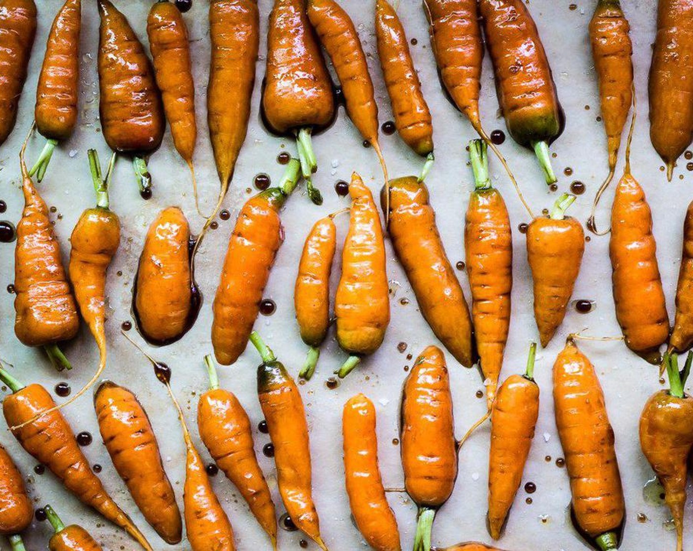 step 4 Spread carrots on the parchment lined baking sheet and sprinkle carrots with Sea Salt Flakes (to taste).