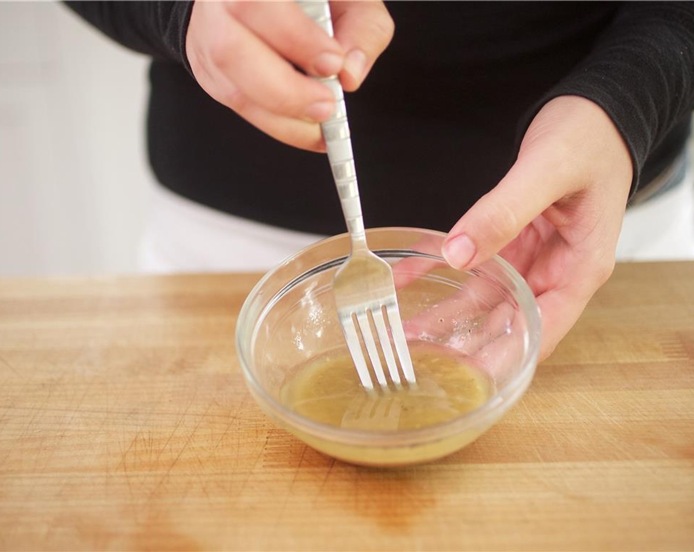 step 7 Finely mince Ground Black Pepper (1/4 tsp) into a paste like consistency and place in a second small bowl. Add the Olive Oil (3 Tbsp), chopped garlic, and Red Wine Vinegar (1 Tbsp). Slowly pour in Anchovies (2) while whisking with a fork until emulsified.