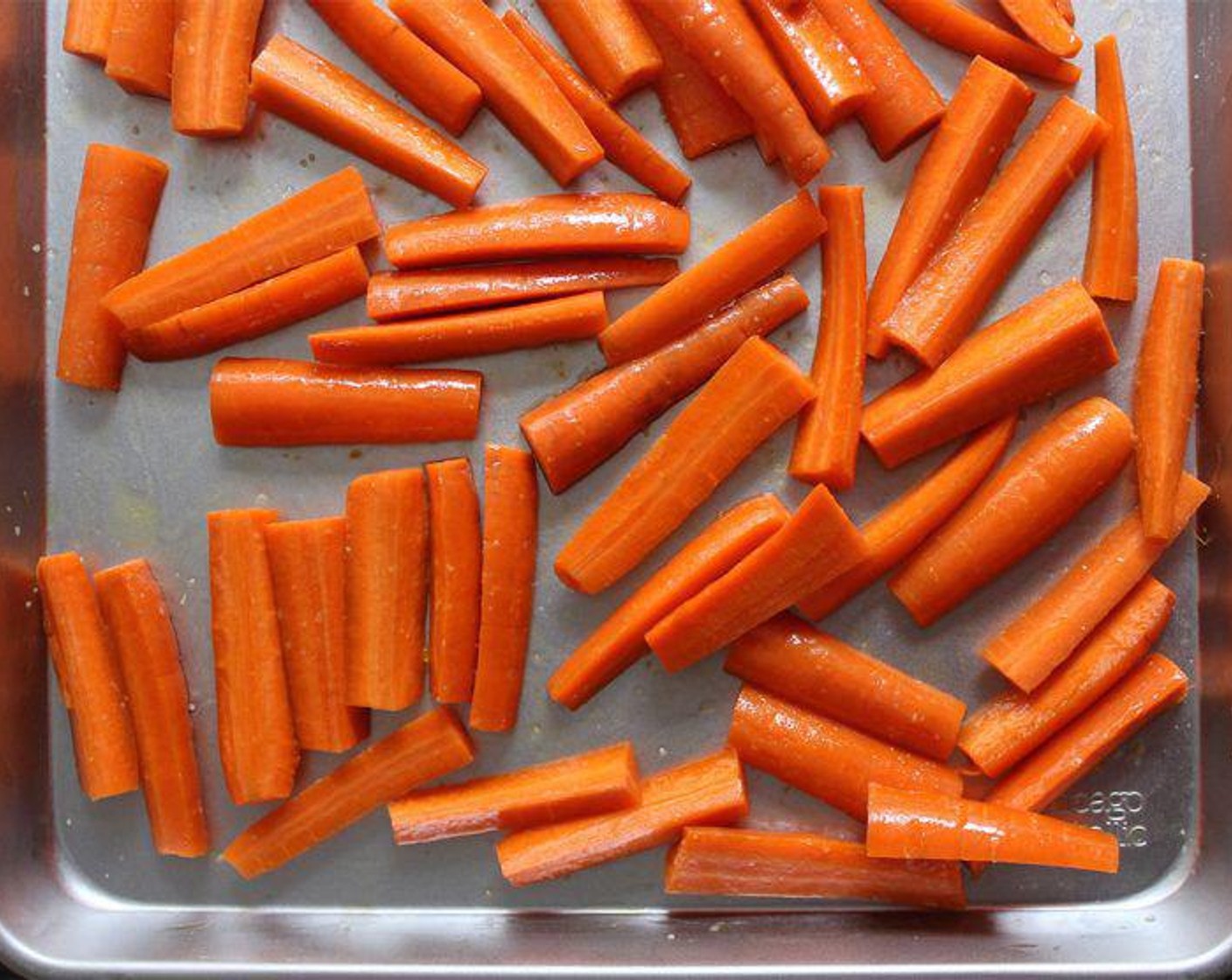 step 2 Cut the Carrots (7 1/2 cups) into pieces that are about 2-3-inches by 1/2-inch thick. Every carrot is different, so don’t worry if your measurements aren’t exact. Place in a large mixing bowl and toss well with the Extra-Virgin Olive Oil (3 Tbsp) and Kosher Salt (1 tsp).