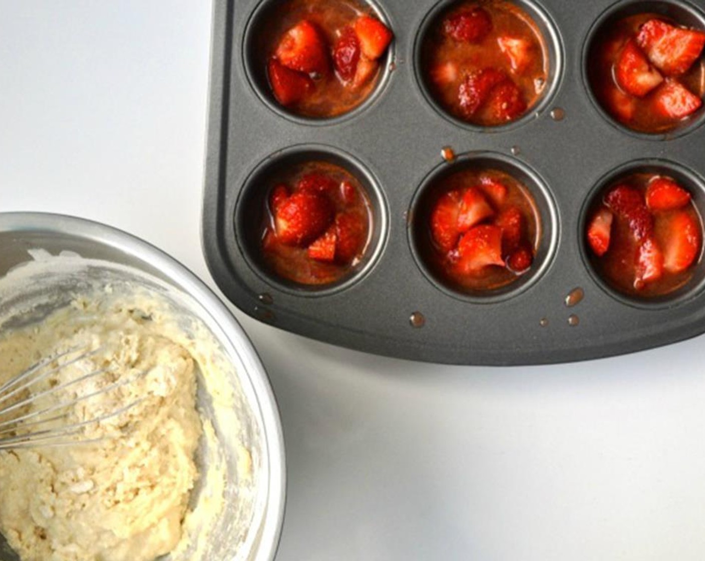 step 4 In a muffin tin, fill each section up 3/4 of the way with equal amounts of strawberries and liquid, about 2 tablespoons per muffin compartment.