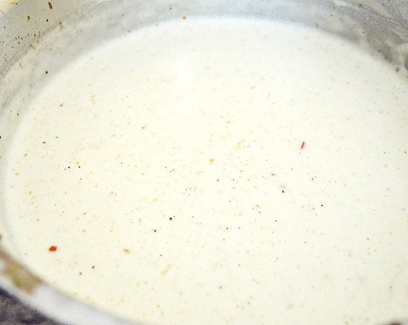 step 6 Keep whisking while you slowly pour in the Milk (3 cups) until you have a lovely white sauce. Whisk in the Salt (1 pinch) and Ground Nutmeg (1/4 tsp) then let the sauce simmer and thicken for 10-15 minutes.
