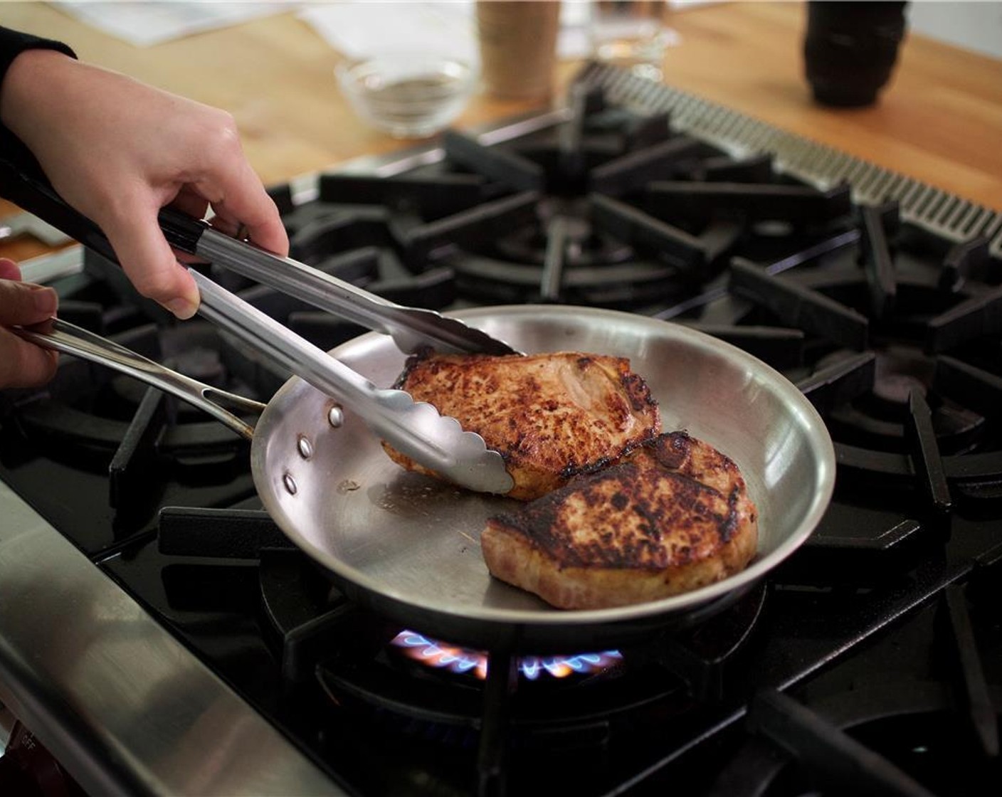 step 14 Heat Olive Oil (1 Tbsp) in a large saute pan over medium high heat. Remove the pork chops from the marinade and add to the pan. Sear on each side for one and a half minutes.