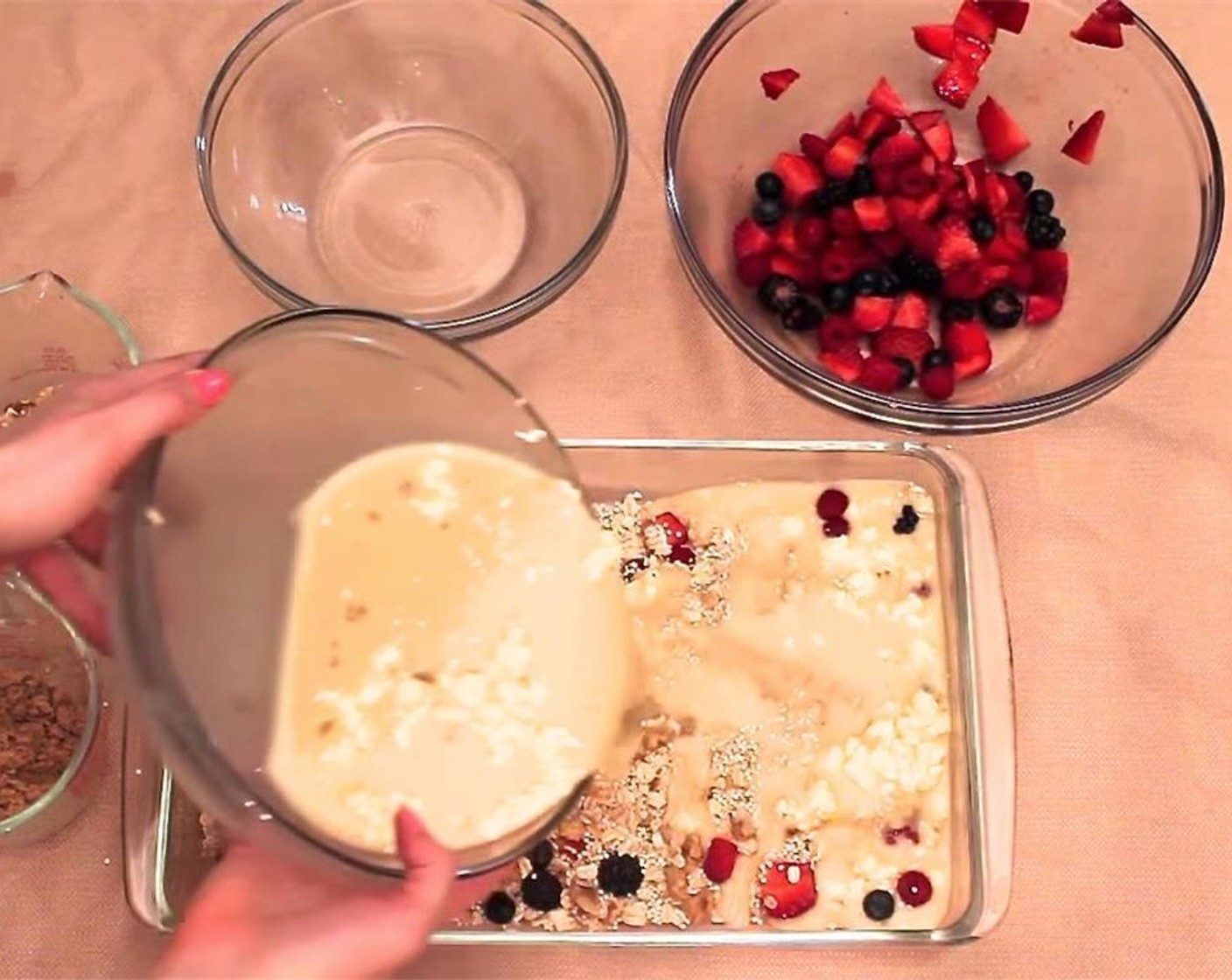 step 5 Shake half the fresh mixed berries into a glass baking dish. Over that, pour first the dry mixture, then the wet. Use a spoon to make sure all dry parts are covered by the wet.