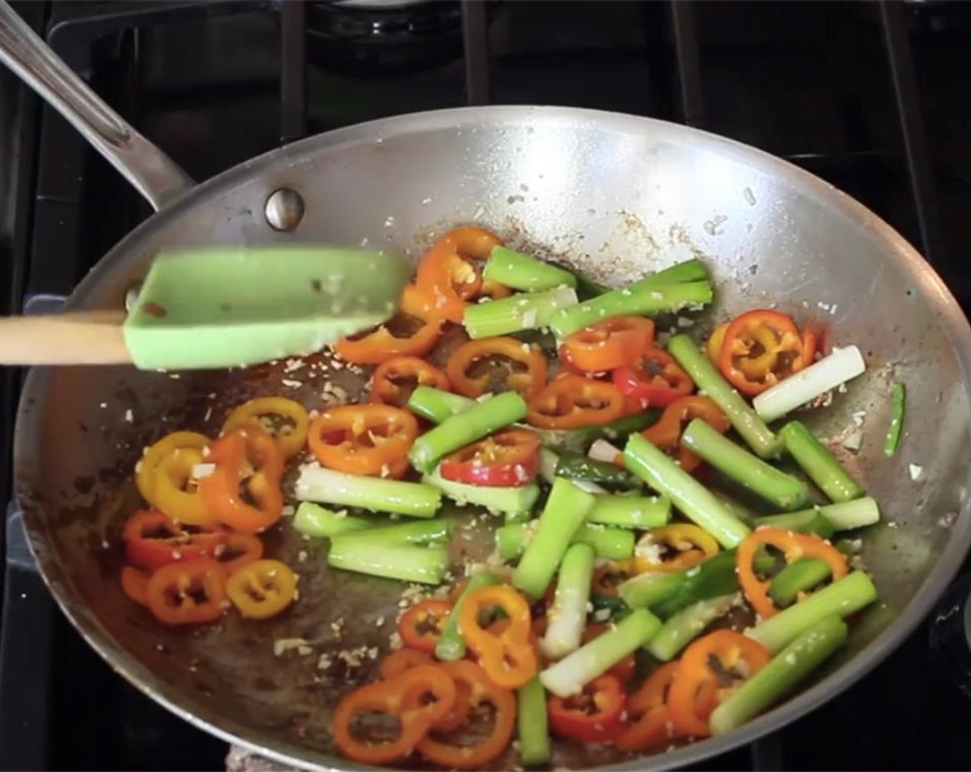 step 9 Add the sliced bell peppers and saute together, for about 1 minute.