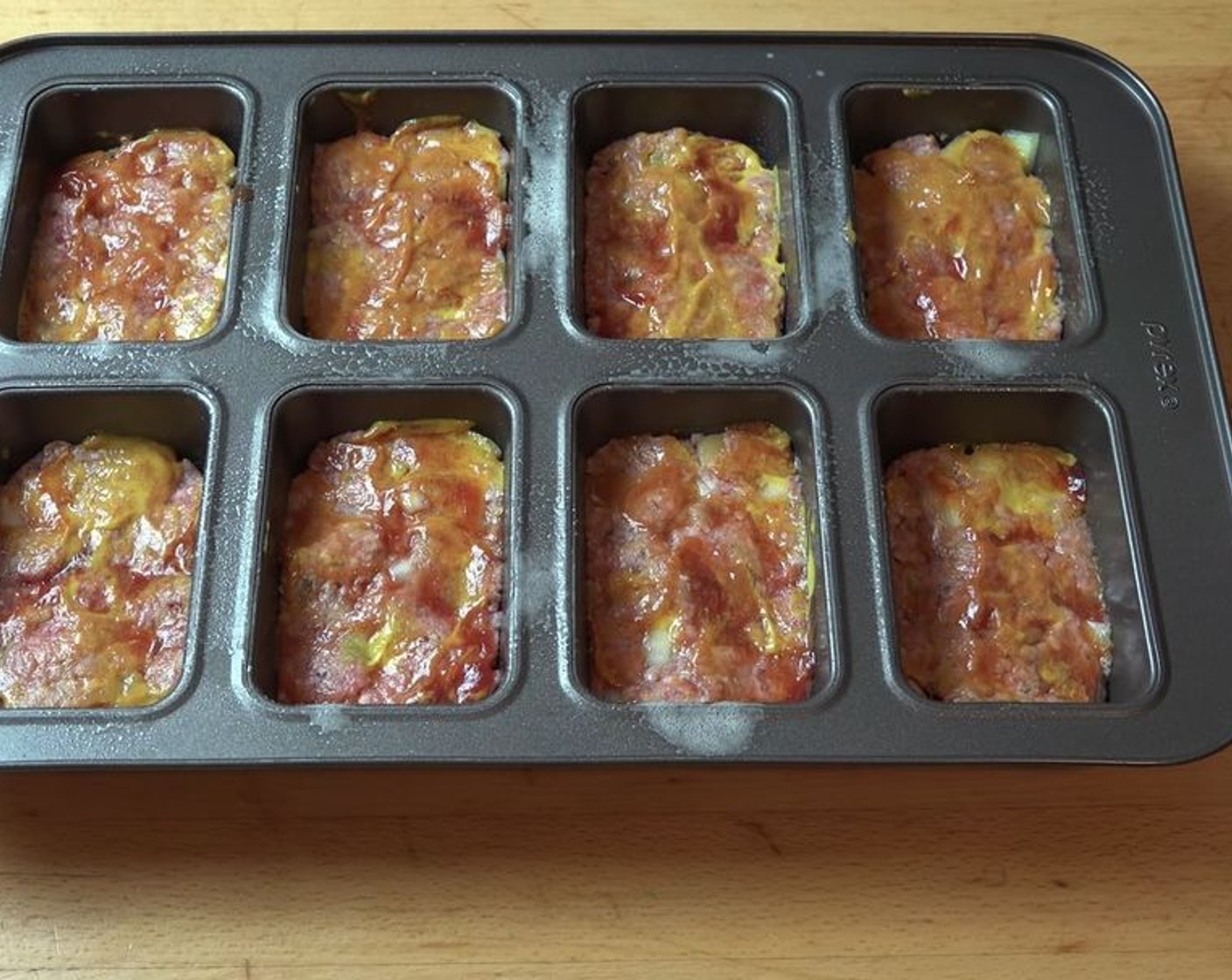 step 5 On top of each mini meatloaf, add Ketchup (to taste) and Yellow Mustard (to taste). Spread over the surface.