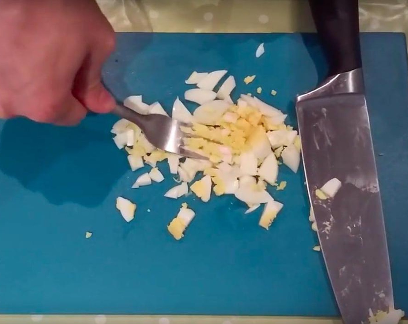 step 3 With a fork and knife, chop the boiled egg.