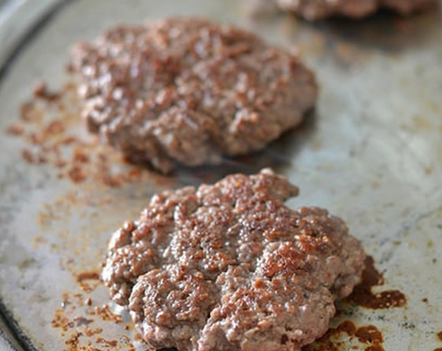 step 4 Add the Vegetable Oil (as needed) to the pan and grill. Don't press on your burgers or you'll lose the juiciness of the burger to the pan. Flip burger a couple of times to distribute said juiciness.