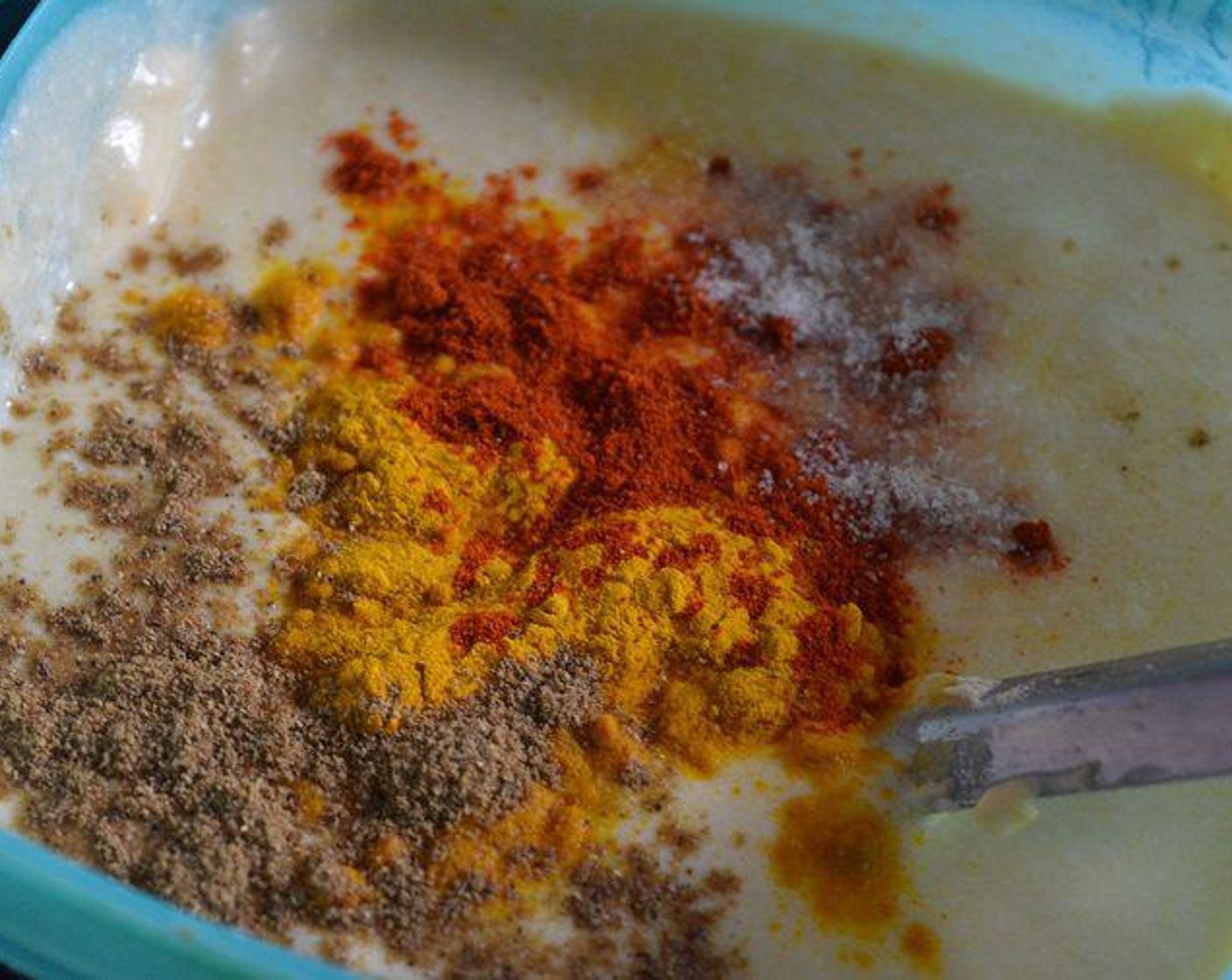 step 6 For the yogurt curry batter: In a big bowl, take the Buttermilk (2 cups), whip it with spatula well to make it smooth and add Chickpea Flour (1 cup). Add Ground Turmeric (1 1/2 Tbsp), Red Chili Powder (1 Tbsp), Garam Masala (1 Tbsp) and Salt (to taste). Add Water (to taste), mix well, make sure there are no lumps. Can you see the flour lump that means i have to dissolve the lumps well. Use a spoon to dissolve the lumps into the curd.