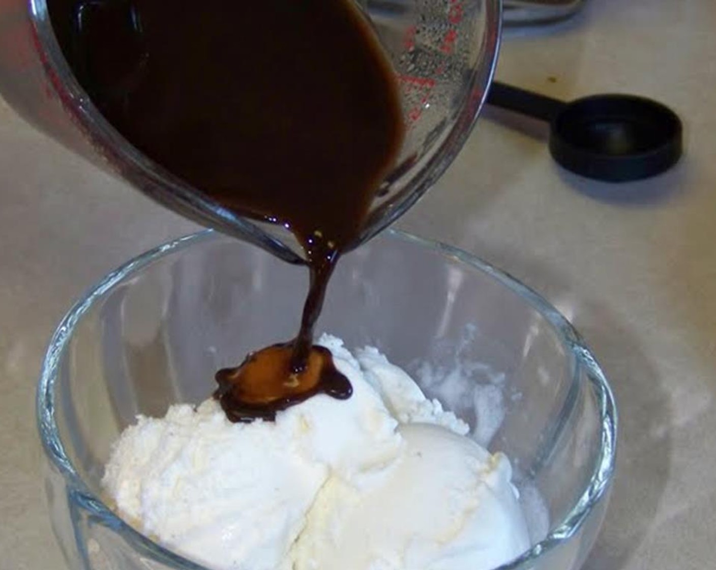 step 1 Stir the Instant Coffee (1 Tbsp) and the Chocolate Syrup (2 Tbsp) into the boiling Water (1/2 cup). Pour over the Vanilla Ice Cream (to taste) just before serving!