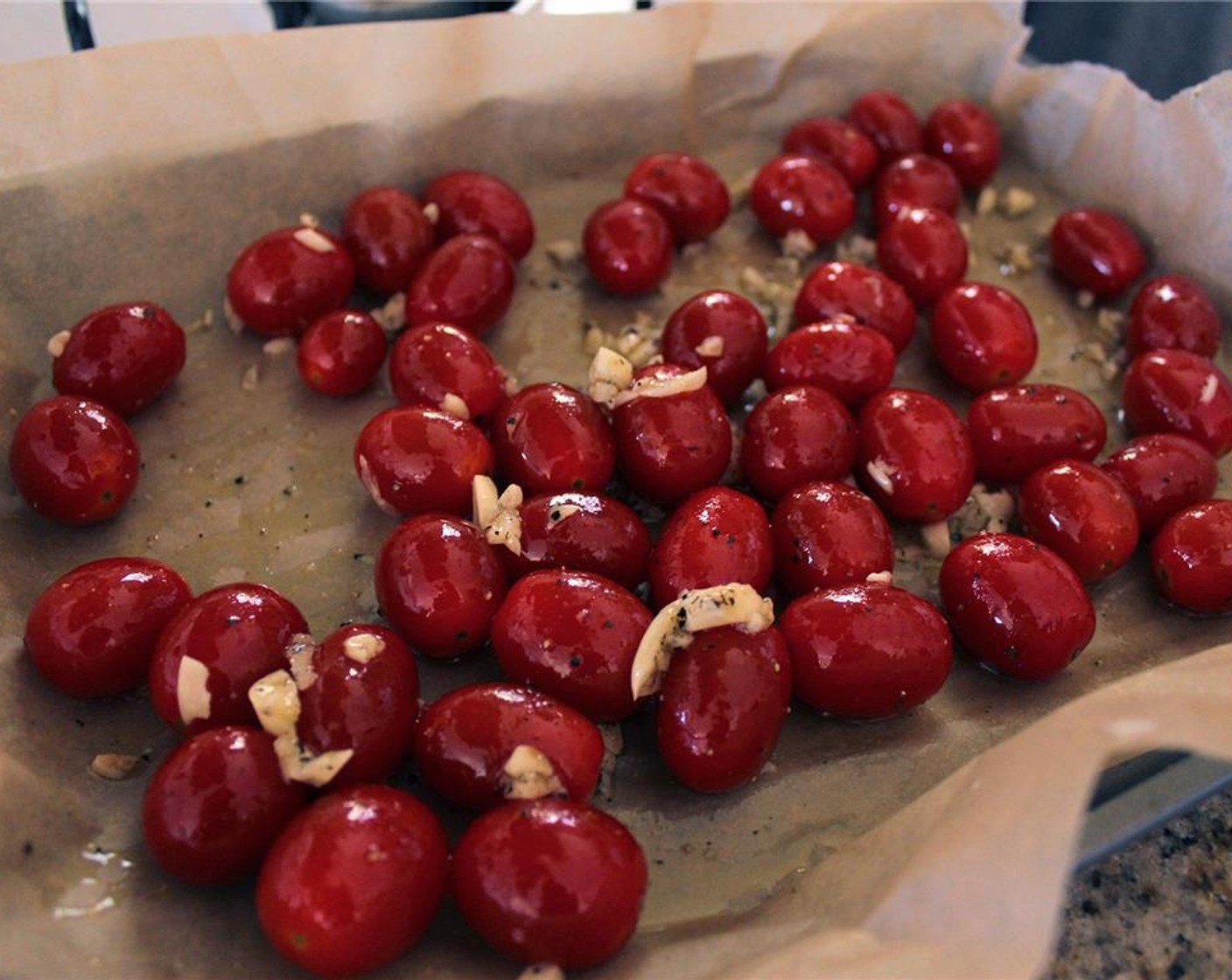 step 3 On a baking sheet, toss the Tomatoes (2 cups) with minced garlic, Olive Oil (1 Tbsp), Salt (to taste), and Ground Black Pepper (to taste). Roast the tomatoes for 20 to 25 minutes, or until they begin to burst.