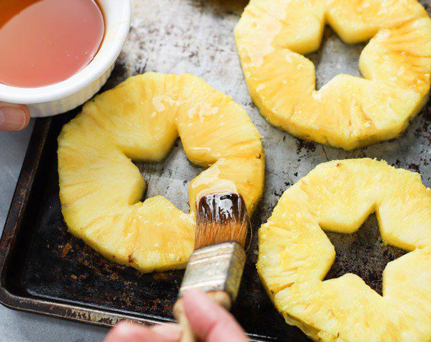 step 5 Slice pineapple into about 1/2 inch thick disks. Punch out the hard cores with a cookie cutter or paring knife.