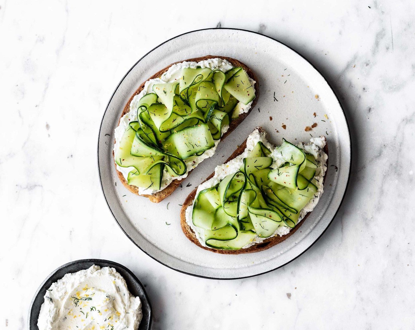 step 5 To serve: spread each slice of toast generously with the lemon herb labneh, top with shaved cucumber and sprinkle with a bit of Crushed Red Pepper Flakes (to taste), lemon zest and a touch of minced fresh herbs.