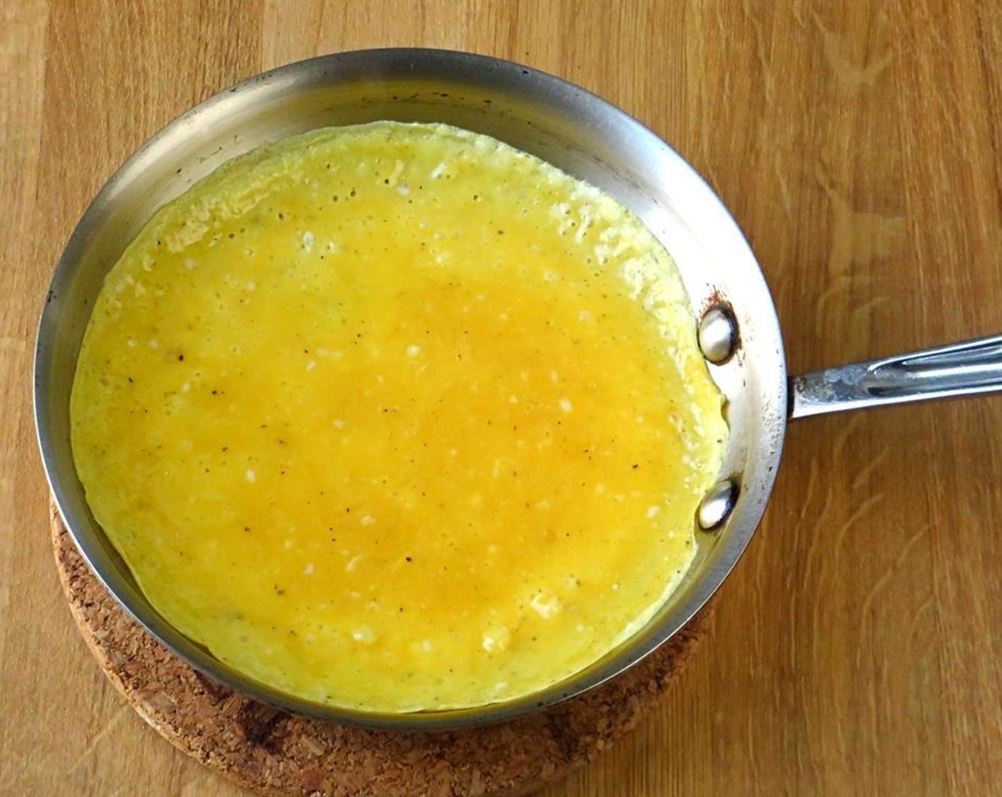 step 7 Swirl the eggs around in the pan so that they coat the bottom and go half way up the sides. Continue this swirling process over the heat until the eggs have mostly set and they are no longer runny.