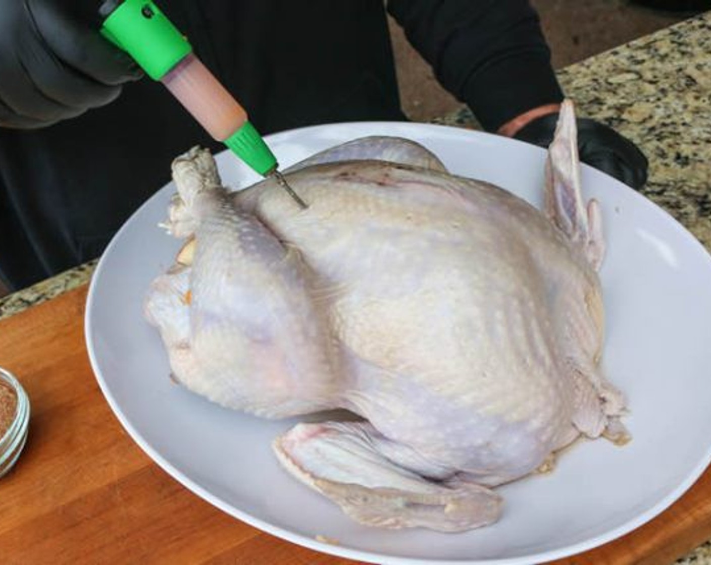 step 9 Place quartered Apple (1) and Onion (1) in the cavity and tie the legs together with butcher twine. Inject the breast, legs, and thighs with Cajun injection. Coat the skin with vegetable cooking spray.