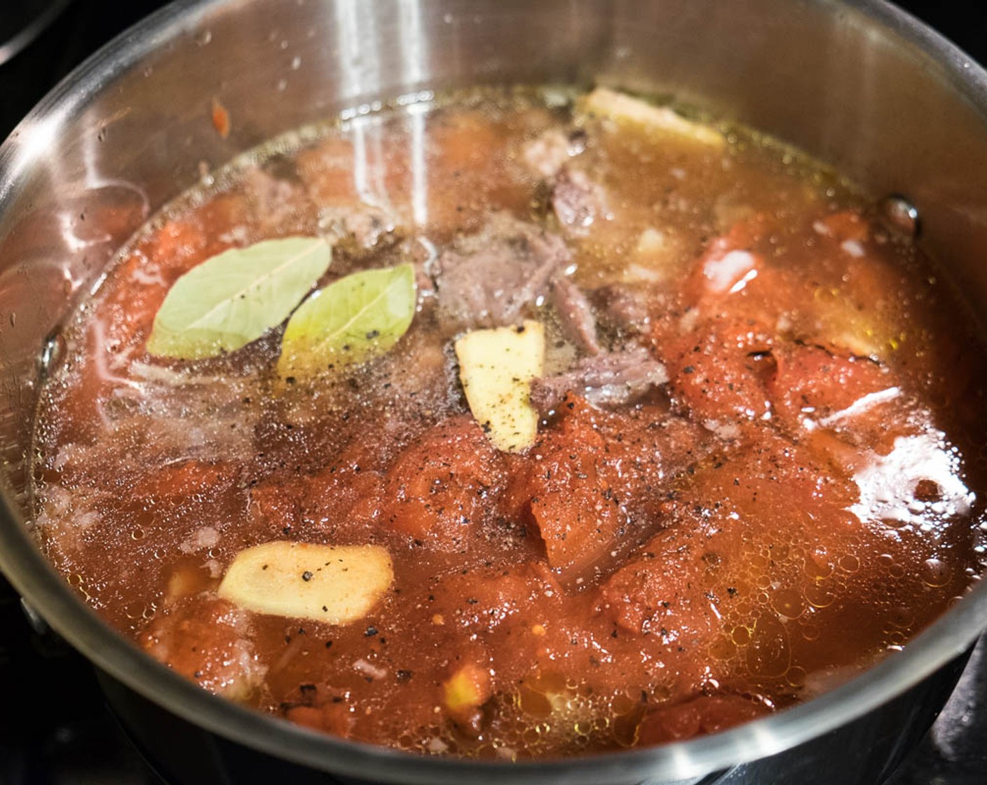 step 7 Transfer the beef broth and beef meat back to the big pot. Add Fresh Ginger (2 in), Yukon Gold Potatoes (4), Green Cabbage (1/4 head), Canned Diced Tomatoes (3 1/2 cups), Tomato Paste (2 Tbsp), Bay Leaves (3), Granulated Sugar (1/2 Tbsp), and 
Ground Black Pepper (1/2 tsp).