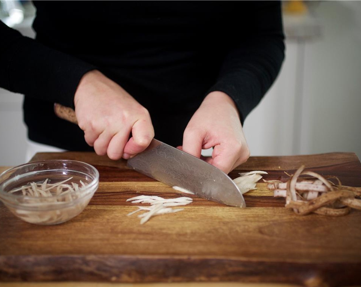 step 5 Meanwhile, peel the Burdock Root (1/2 cup) and slice thinly on the bias. Lay the sliced pieces flat and slice thinly again, creating a julienne. Place in a small bowl with cool water to cover.