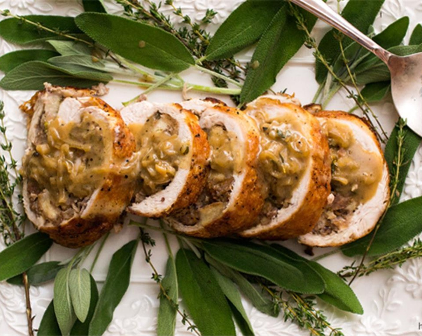 step 16 Cut the twine from the roulade and slice into 1/2-inch rounds. Plate and serve with the gravy. Enjoy!