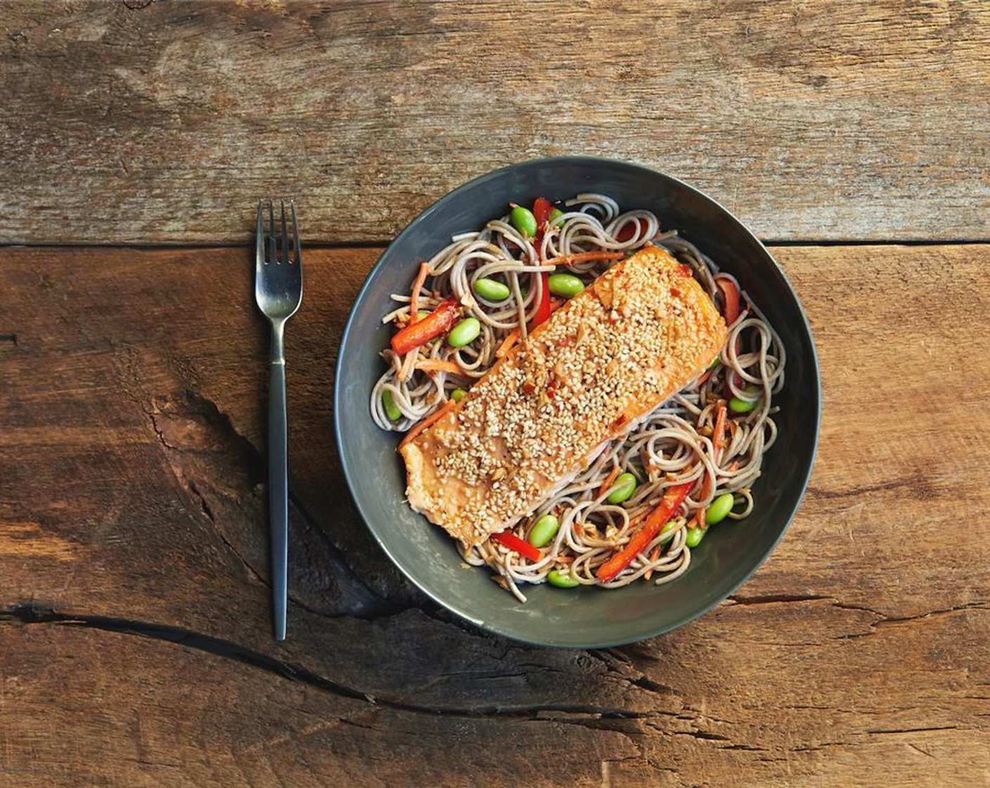 step 13 In the center of two bowls place the soba noodle salad. Top with salmon and drizzle with sauce. Serve immediately.